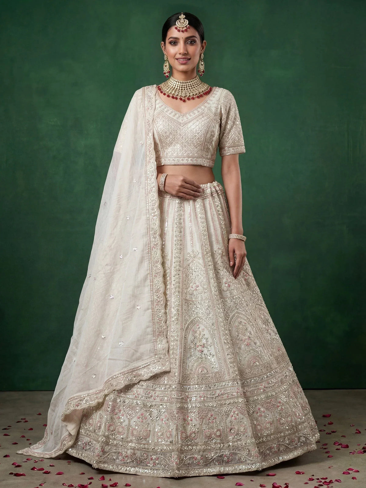 Elegant ivory lehenga choli with intricate embroidery and sequin detailing, perfect for weddings and festive occasions.