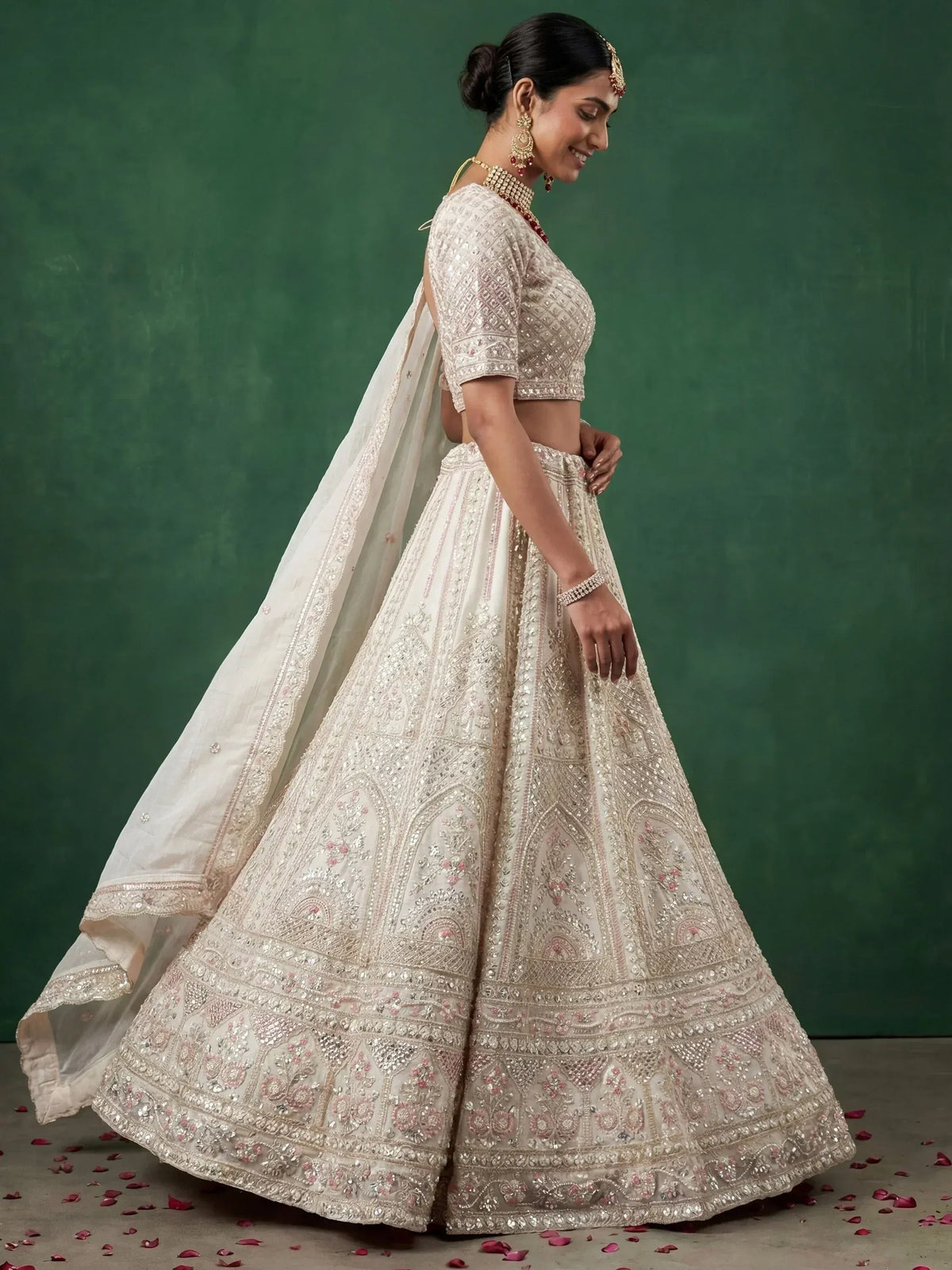 Elegant ivory lehenga choli with intricate embroidery and floral details, perfect for Indian weddings.