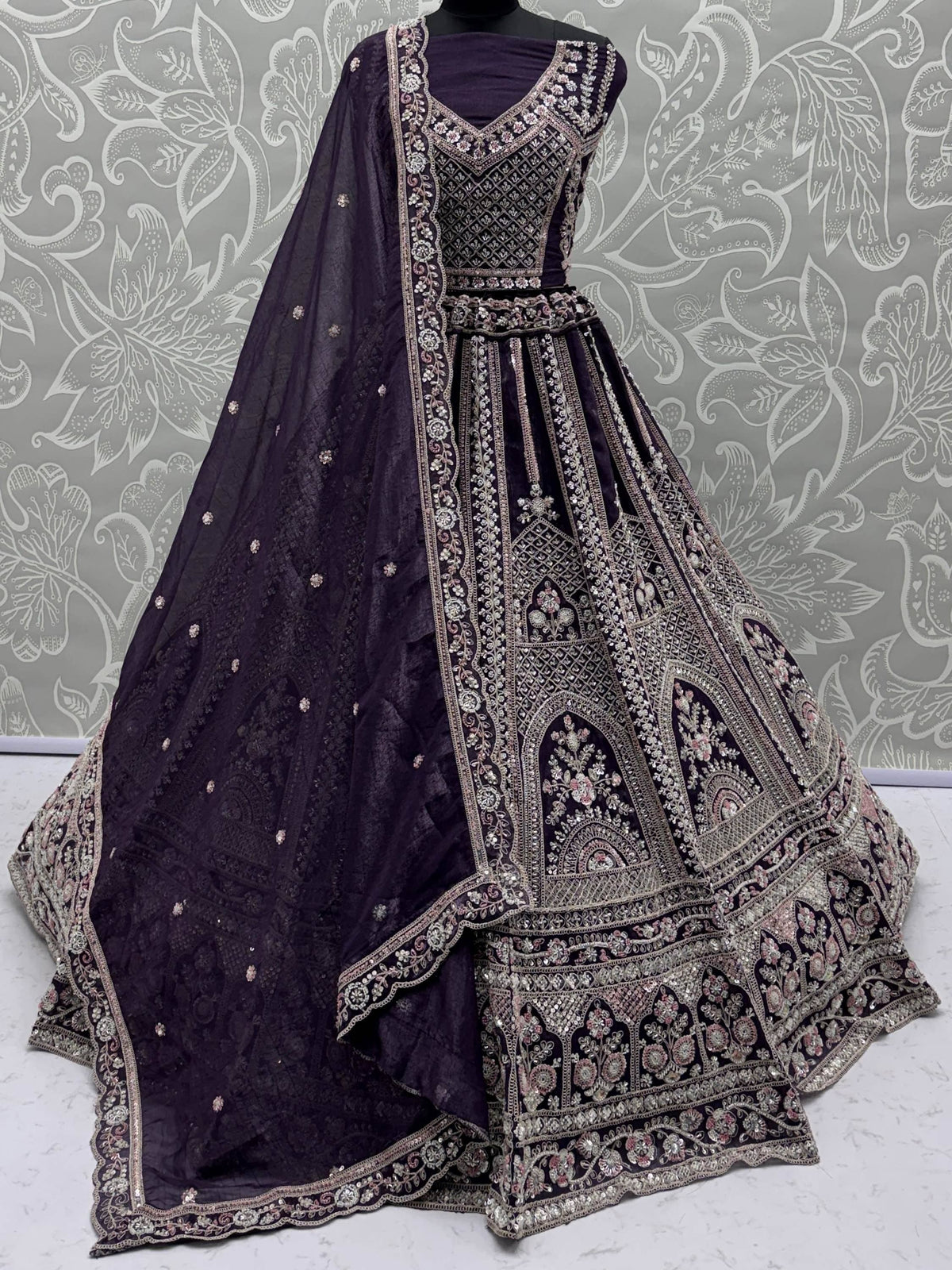 Elegant purple designer lehenga choli with intricate embroidery and embellishments