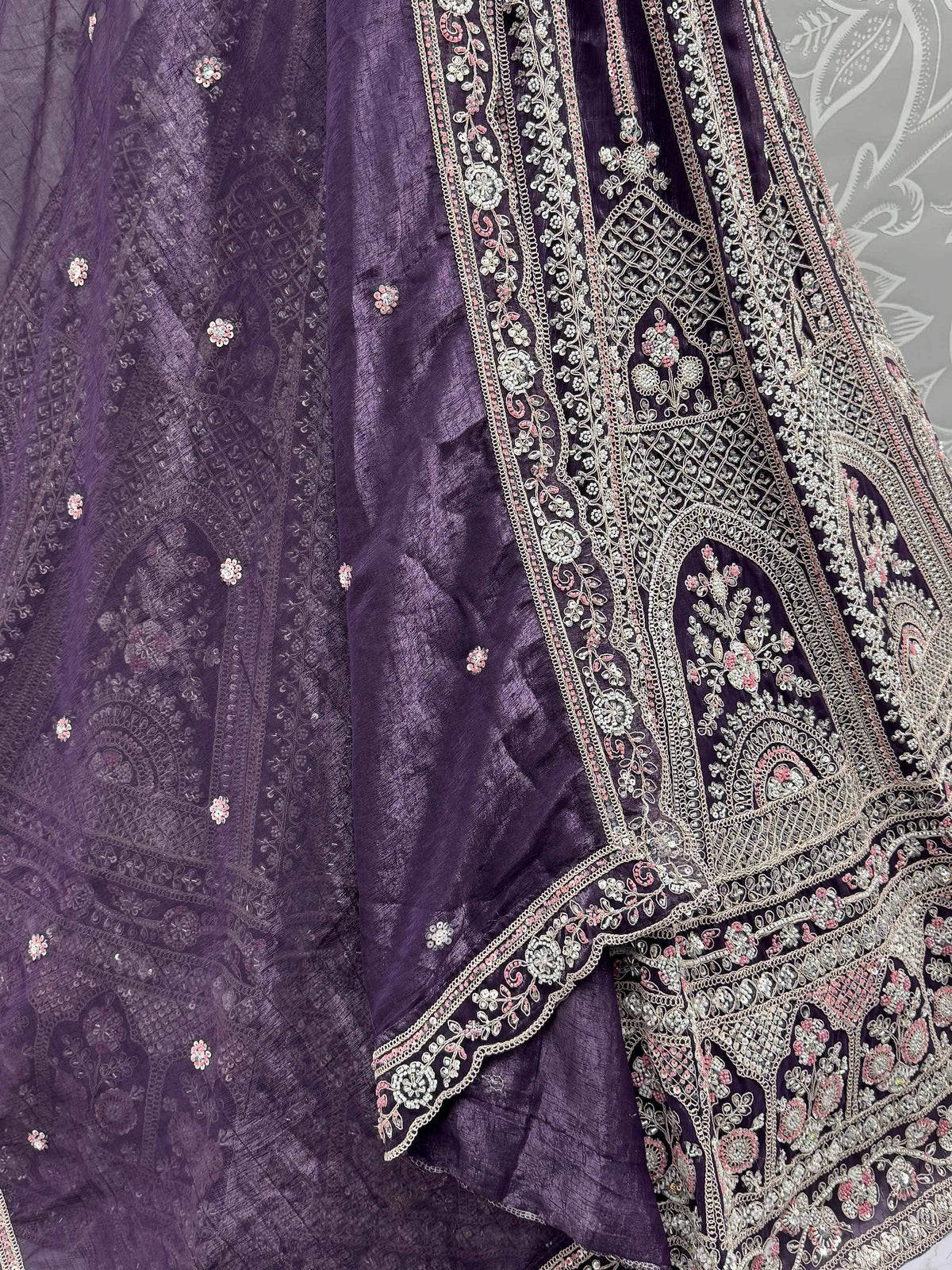 Purple ethnic lehenga with intricate floral embroidery and embellishments