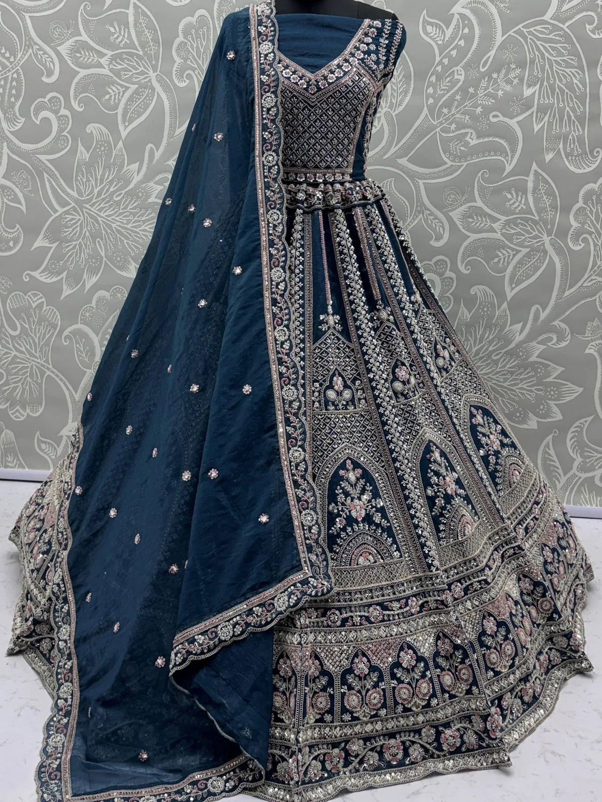 Elegant navy blue lehenga choli with intricate silver and pink embroidery, perfect for Indian ethnic wear.