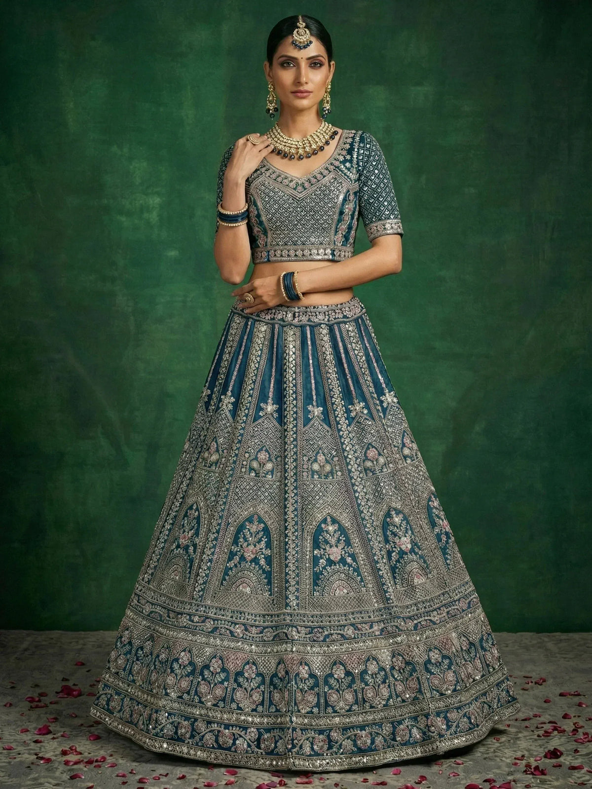 Elegant blue embroidered lehenga choli with intricate designs and traditional jewelry