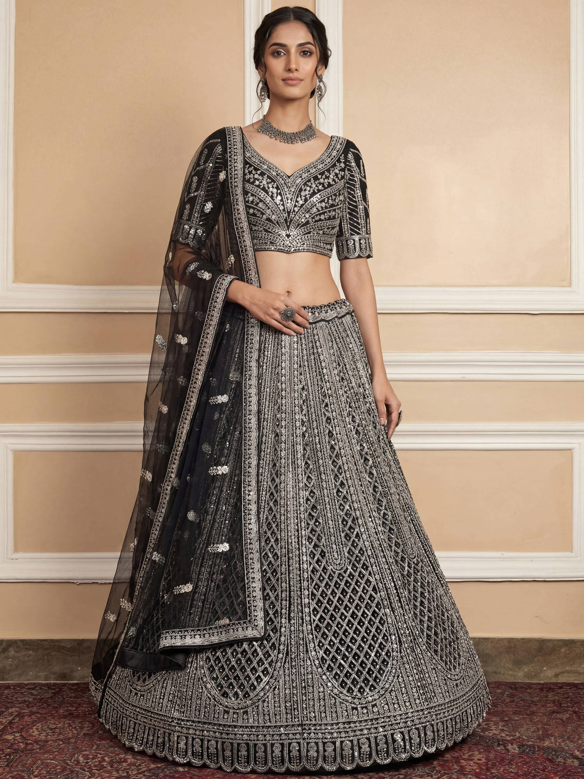 Black and silver embroidered lehenga choli with intricate designs and matching dupatta