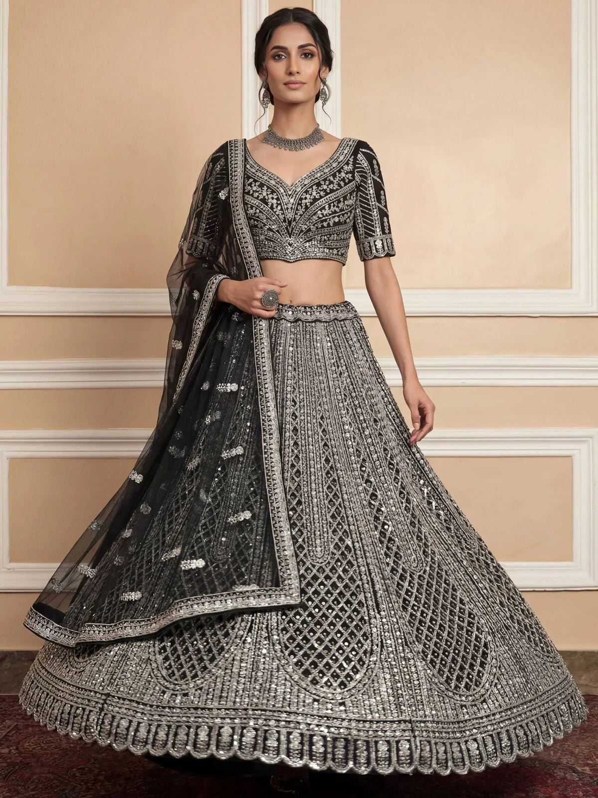 Black and silver embroidered lehenga choli with net dupatta, perfect for weddings and parties.