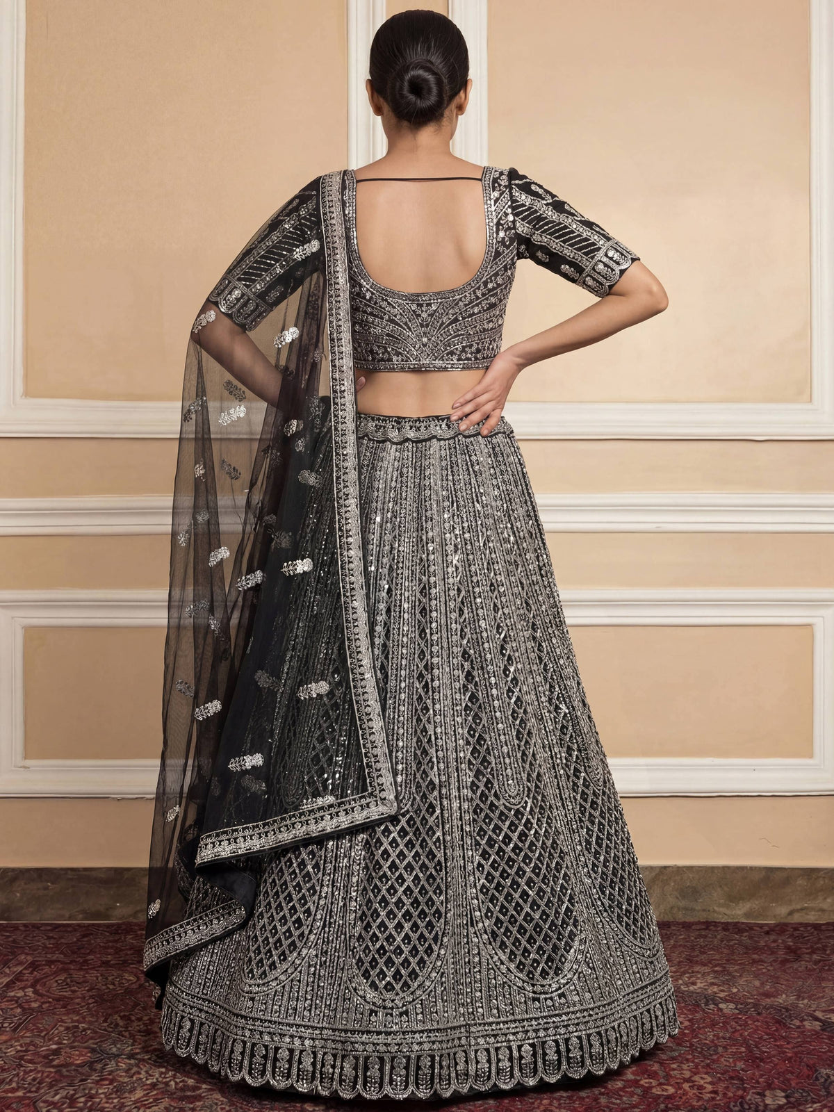Black and silver embroidered lehenga choli with sheer dupatta, back view