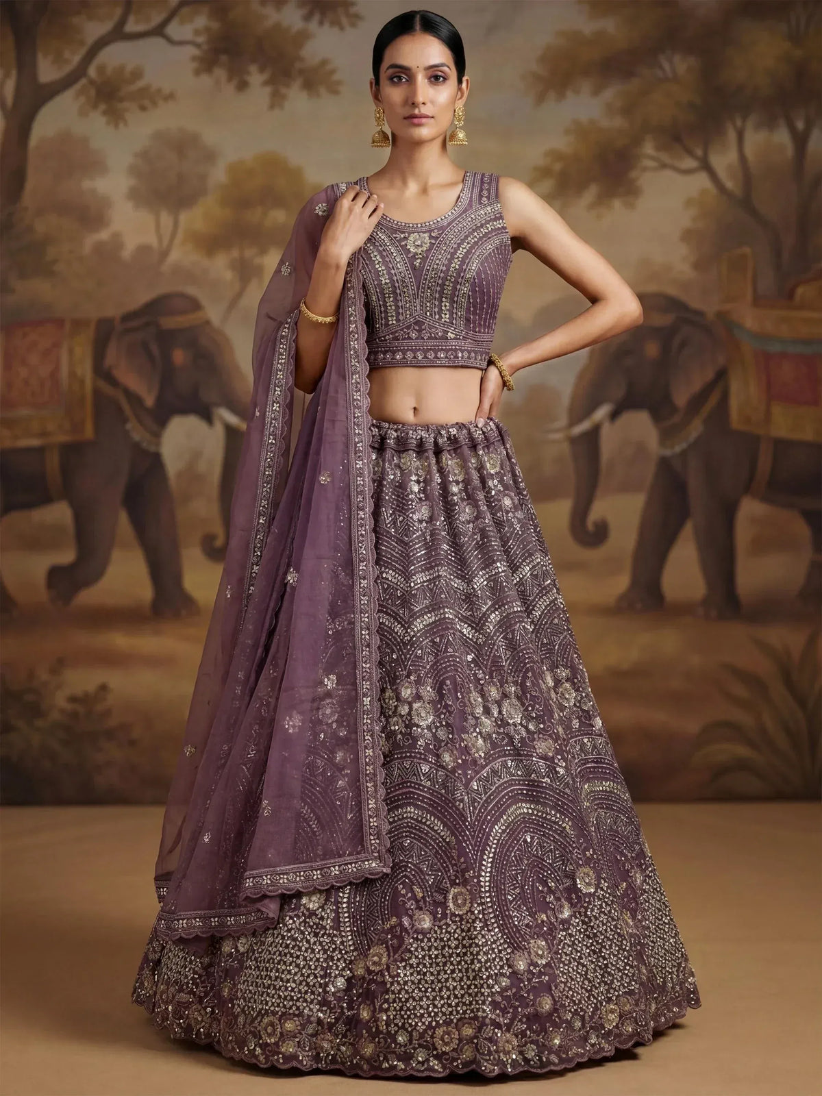 Elegant purple lehenga choli with intricate gold embroidery, perfect for Indian weddings and festive occasions.