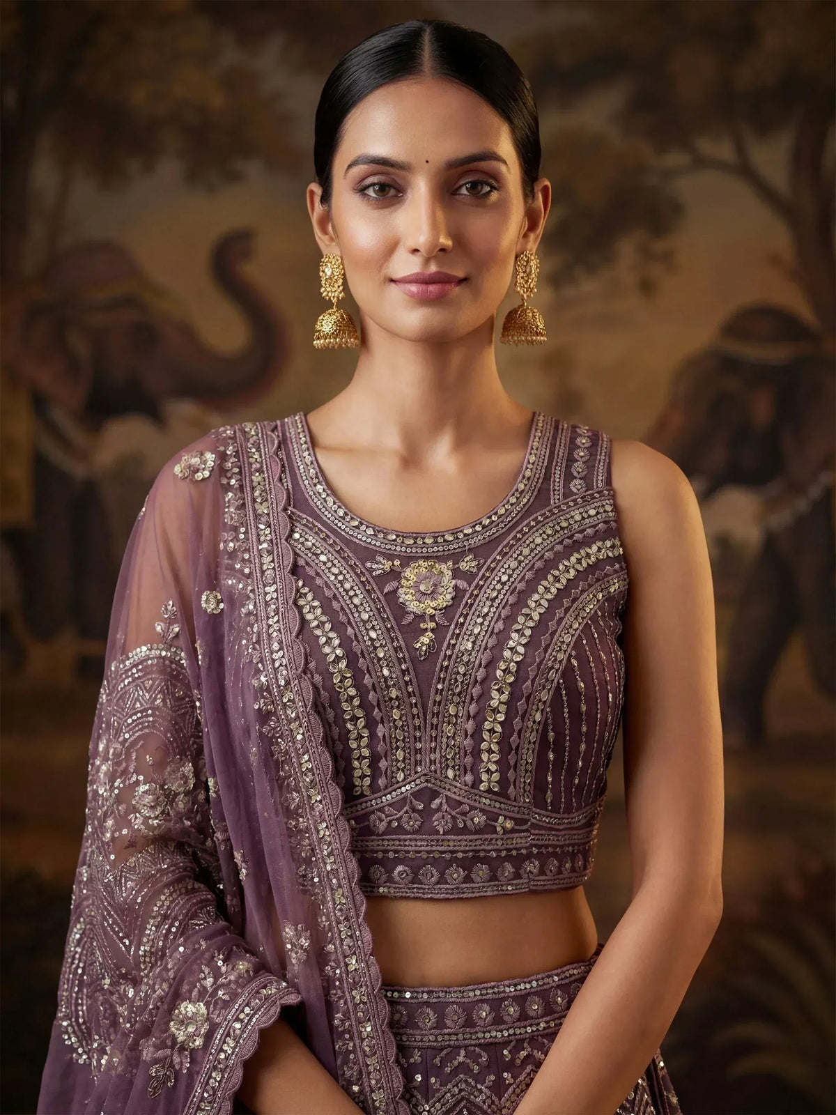 Elegant purple embroidered lehenga choli with sheer dupatta, perfect for Indian ethnic wear occasions.