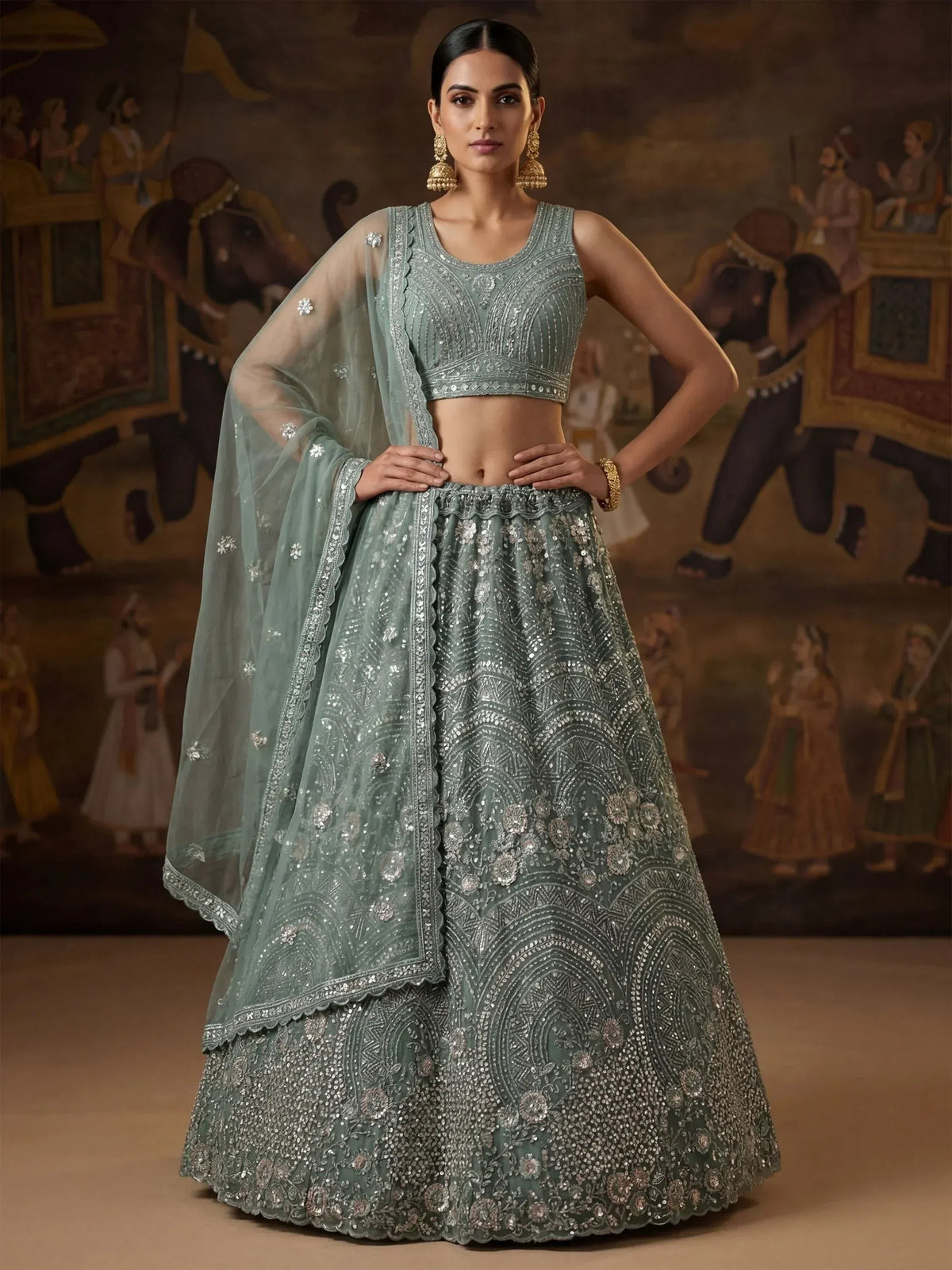 Mint green designer lehenga choli with heavy silver embroidery and sheer dupatta, perfect for weddings and festivals.