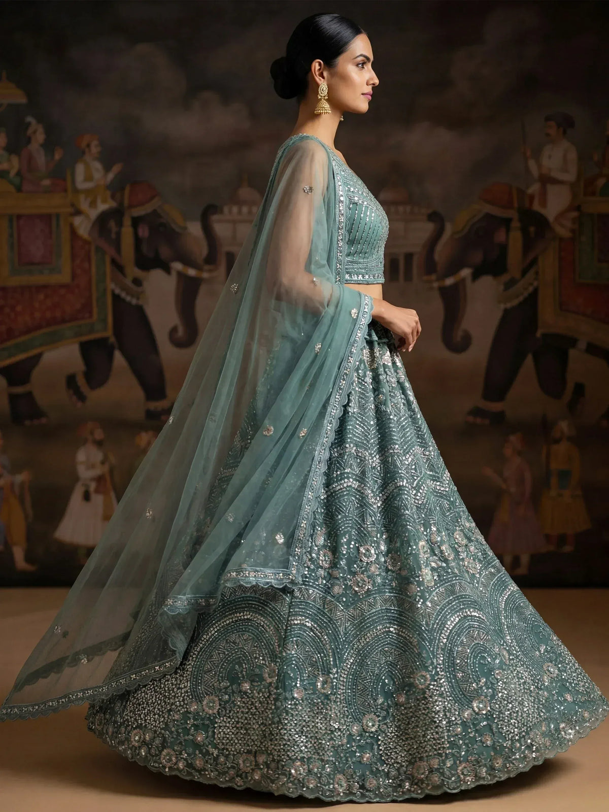 Teal designer lehenga choli with intricate silver embroidery and sheer dupatta, perfect for weddings and festive occasions.