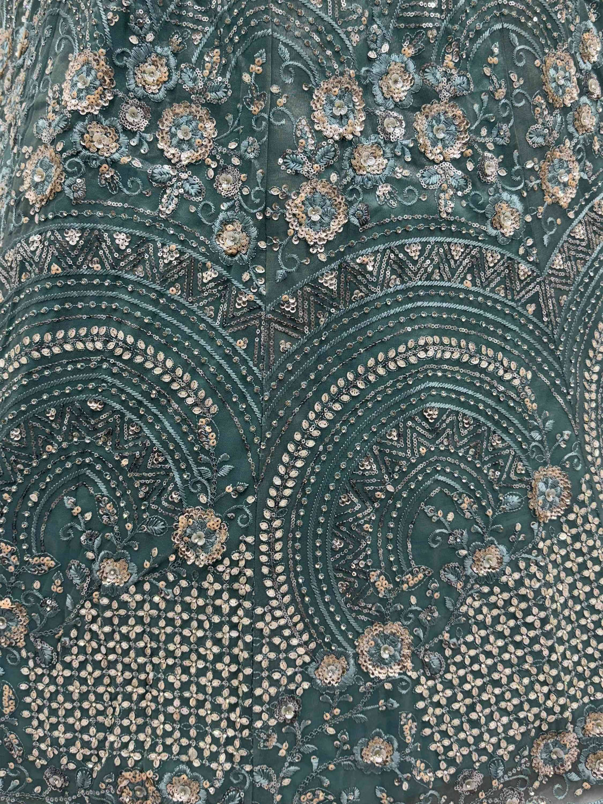 Emerald green designer lehenga with intricate gold sequin and floral embroidery detail