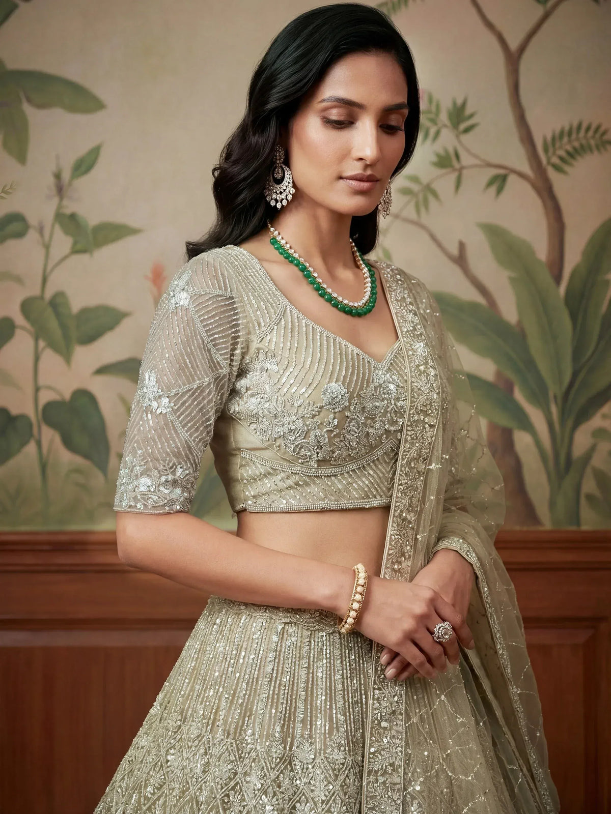 Elegant beige embroidered lehenga choli with sheer dupatta, perfect for Indian weddings and festive occasions.