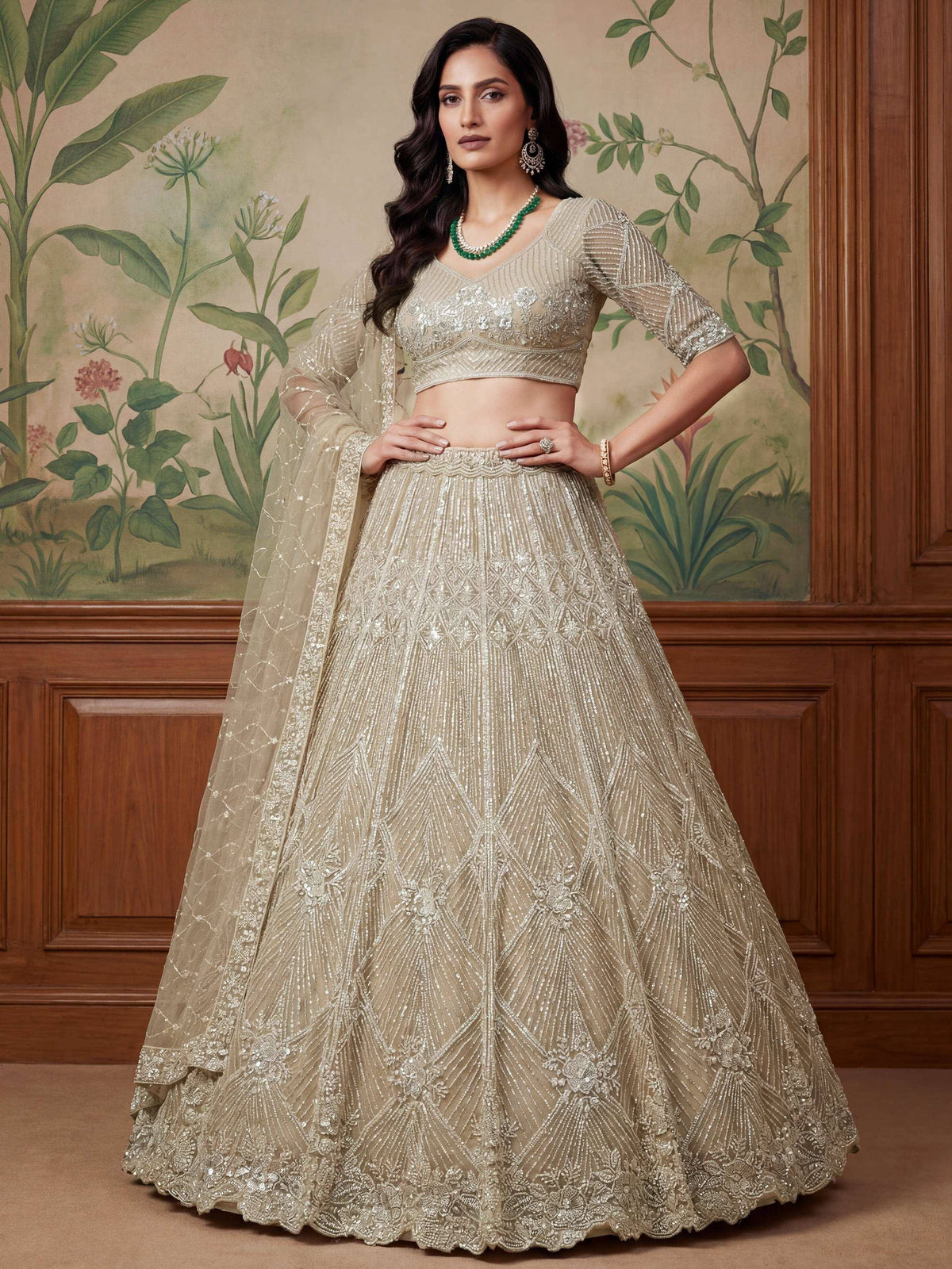 Elegant beige embroidered lehenga choli with sheer dupatta, perfect for Indian weddings and festive occasions.