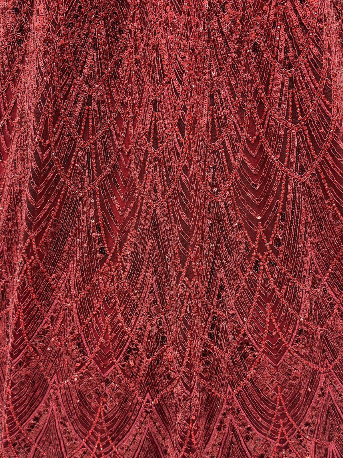 Red sequin embroidered ethnic wear fabric with geometric patterns, perfect for designer lehenga or saree