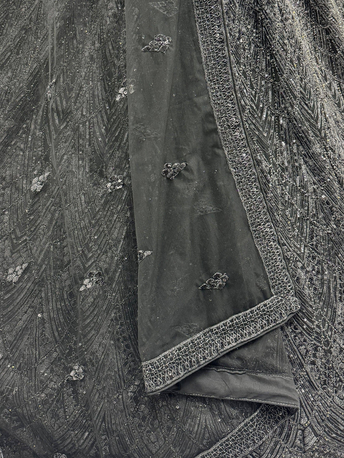 Black ethnic gown with intricate silver embroidery and sequin detailing, perfect for festive occasions.