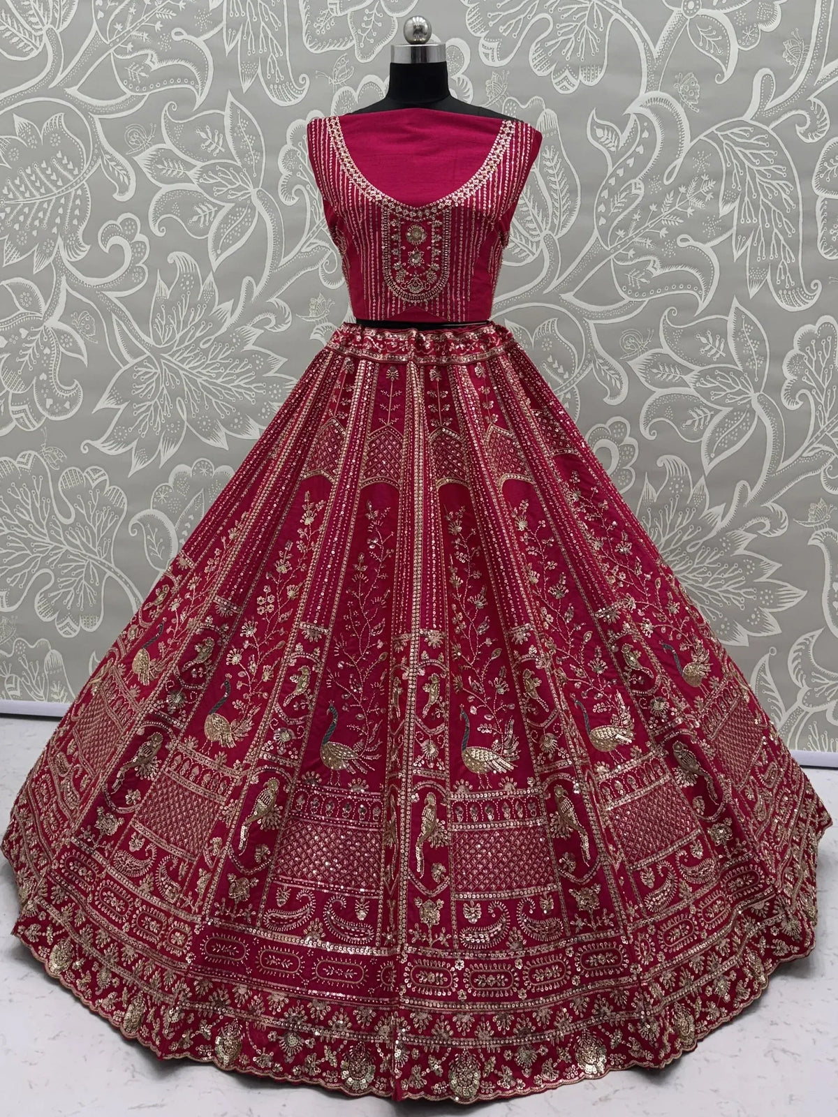 Magenta designer lehenga choli with intricate gold embroidery and peacock motifs