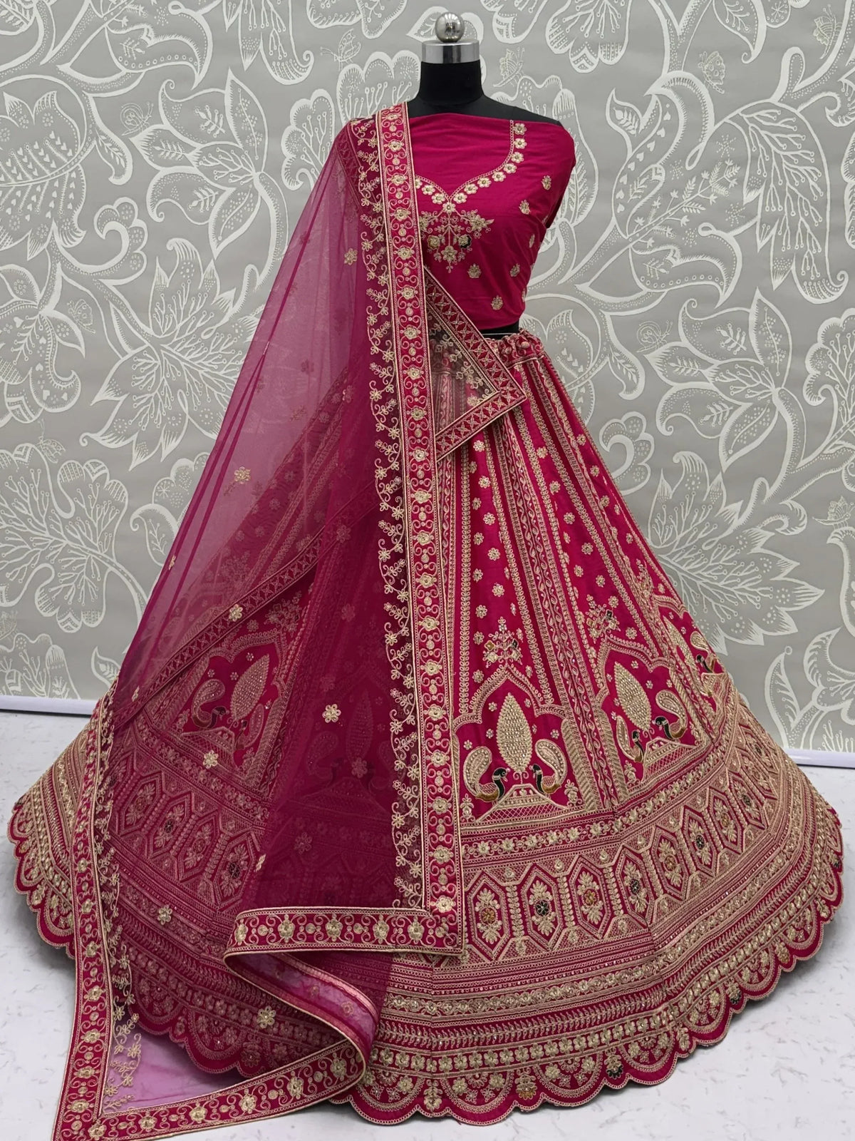 Deep pink designer lehenga choli with intricate gold embroidery and matching dupatta