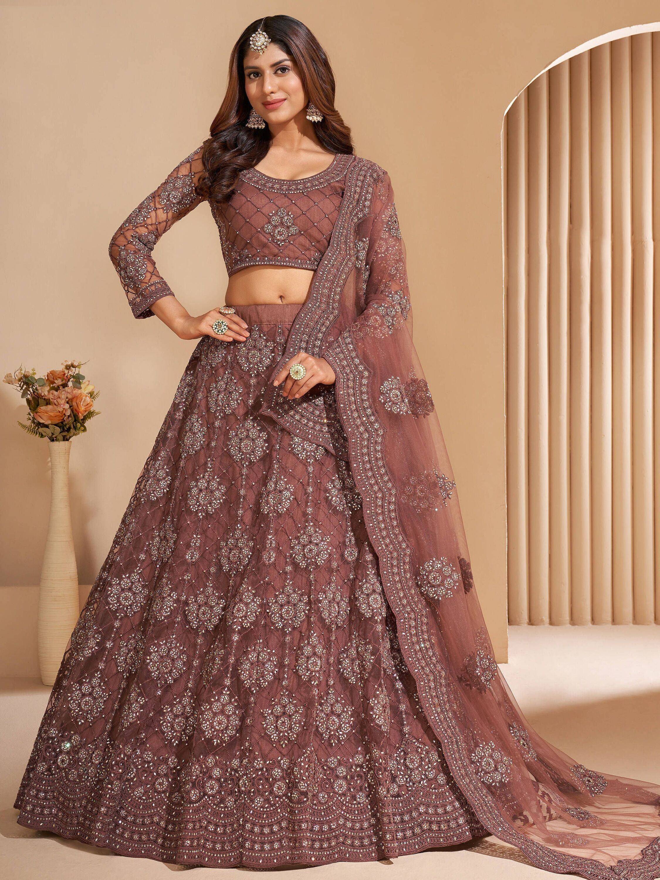Elegant mauve lehenga choli with heavy embroidery and sheer dupatta, perfect for Indian weddings and festive occasions.
