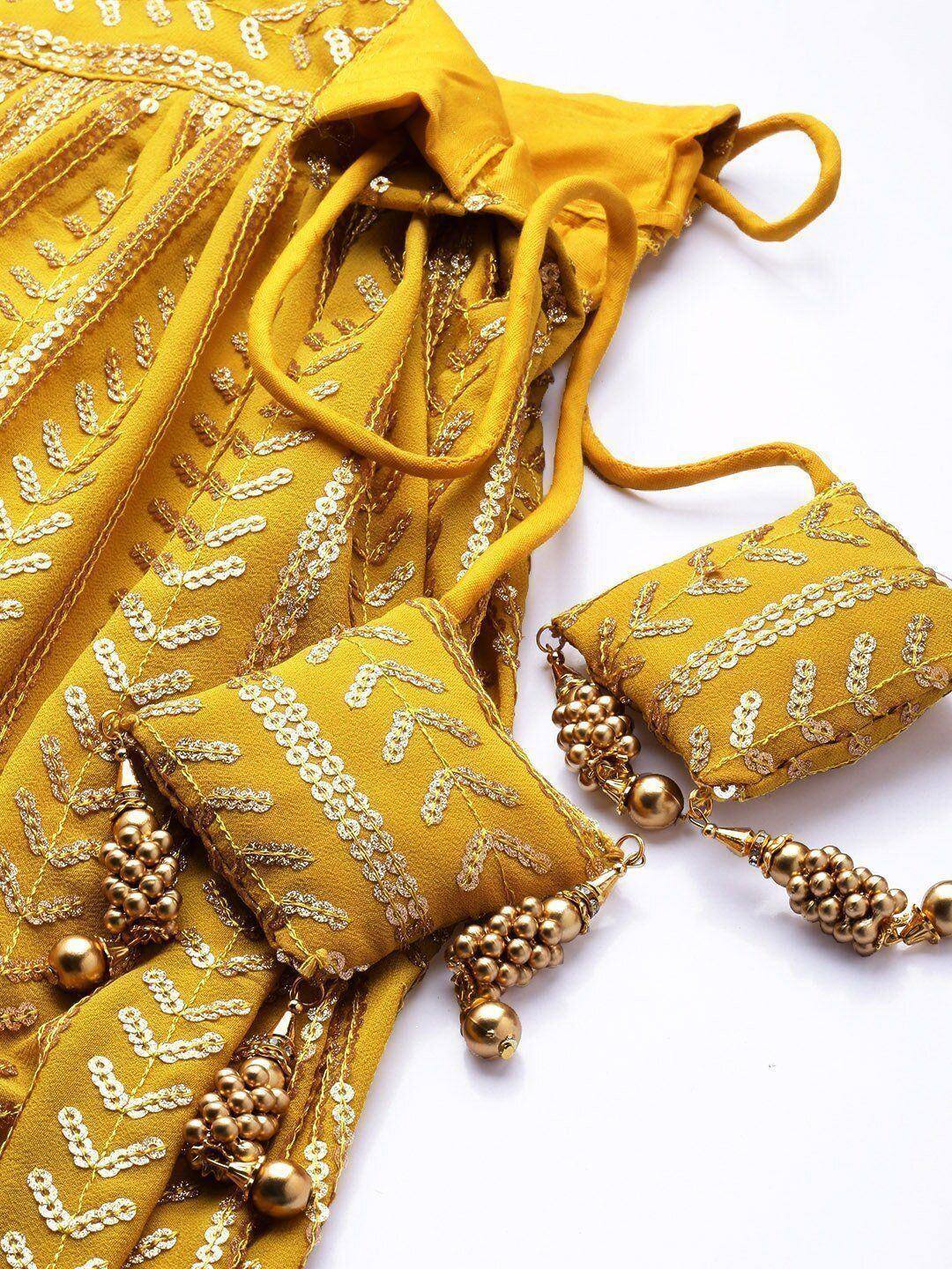 Yellow ethnic lehenga with gold embroidery and matching potli bags, perfect for Indian weddings and festive occasions.