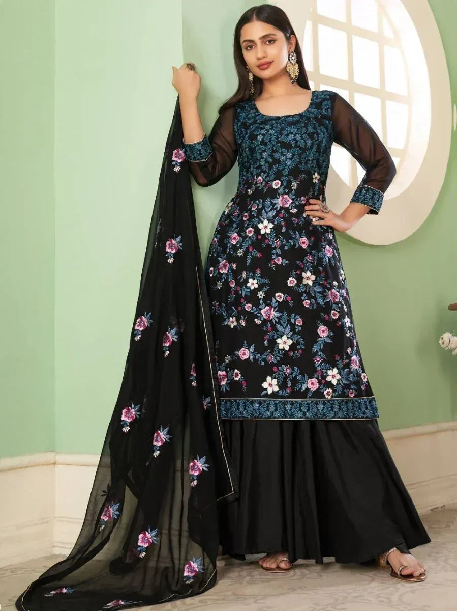 Woman wearing black floral embroidered Indian salwar kameez with matching dupatta