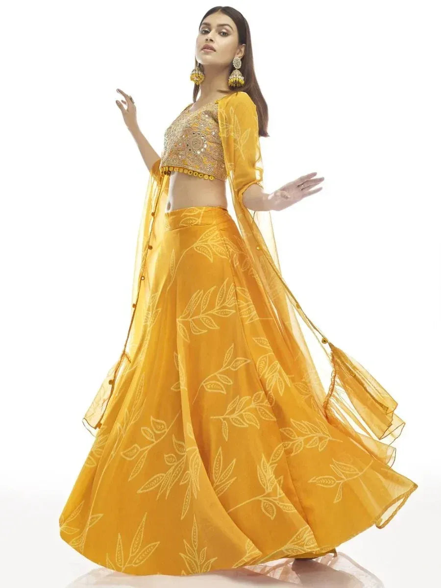 Yellow designer lehenga choli with leaf print and embellished blouse, perfect for ethnic occasions