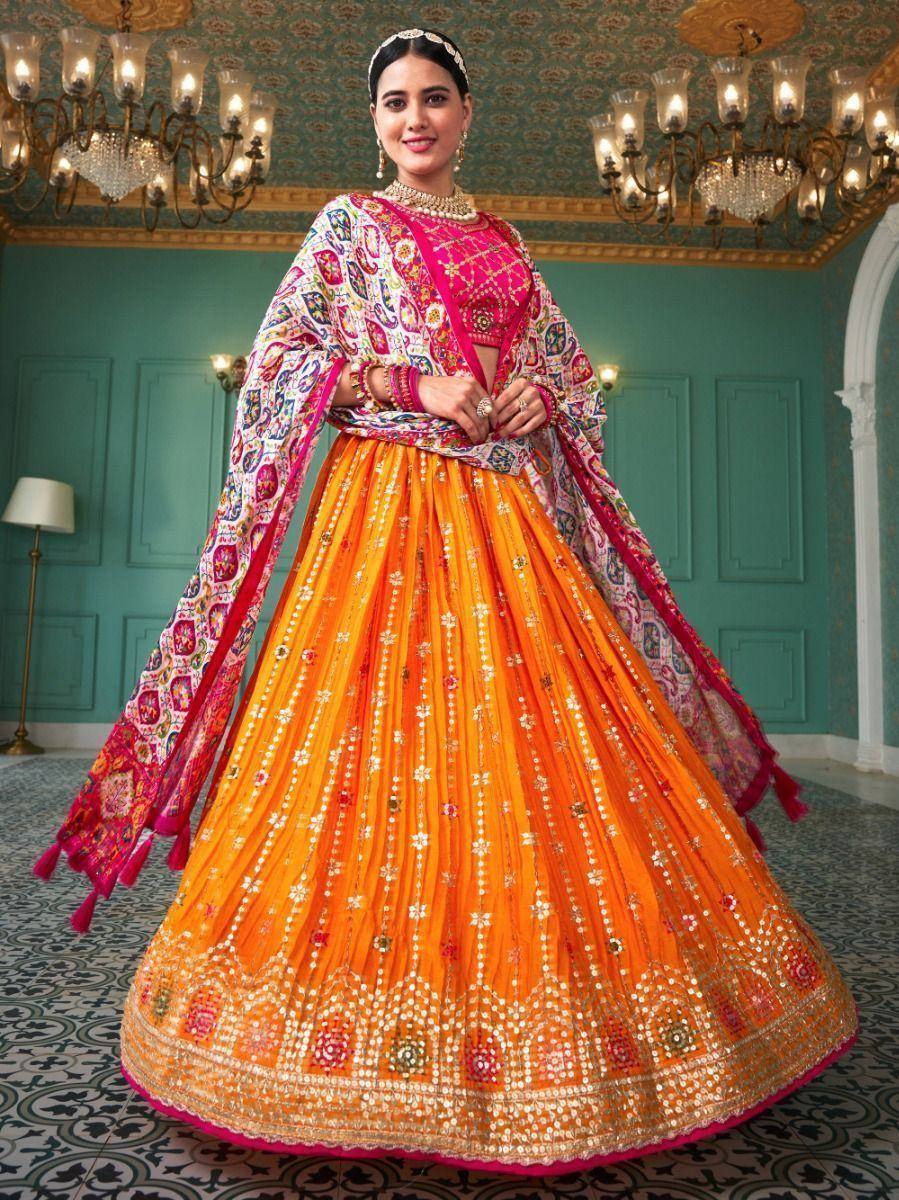 Vibrant orange lehenga choli with pink blouse and embroidered dupatta, perfect for Indian ethnic wear occasions