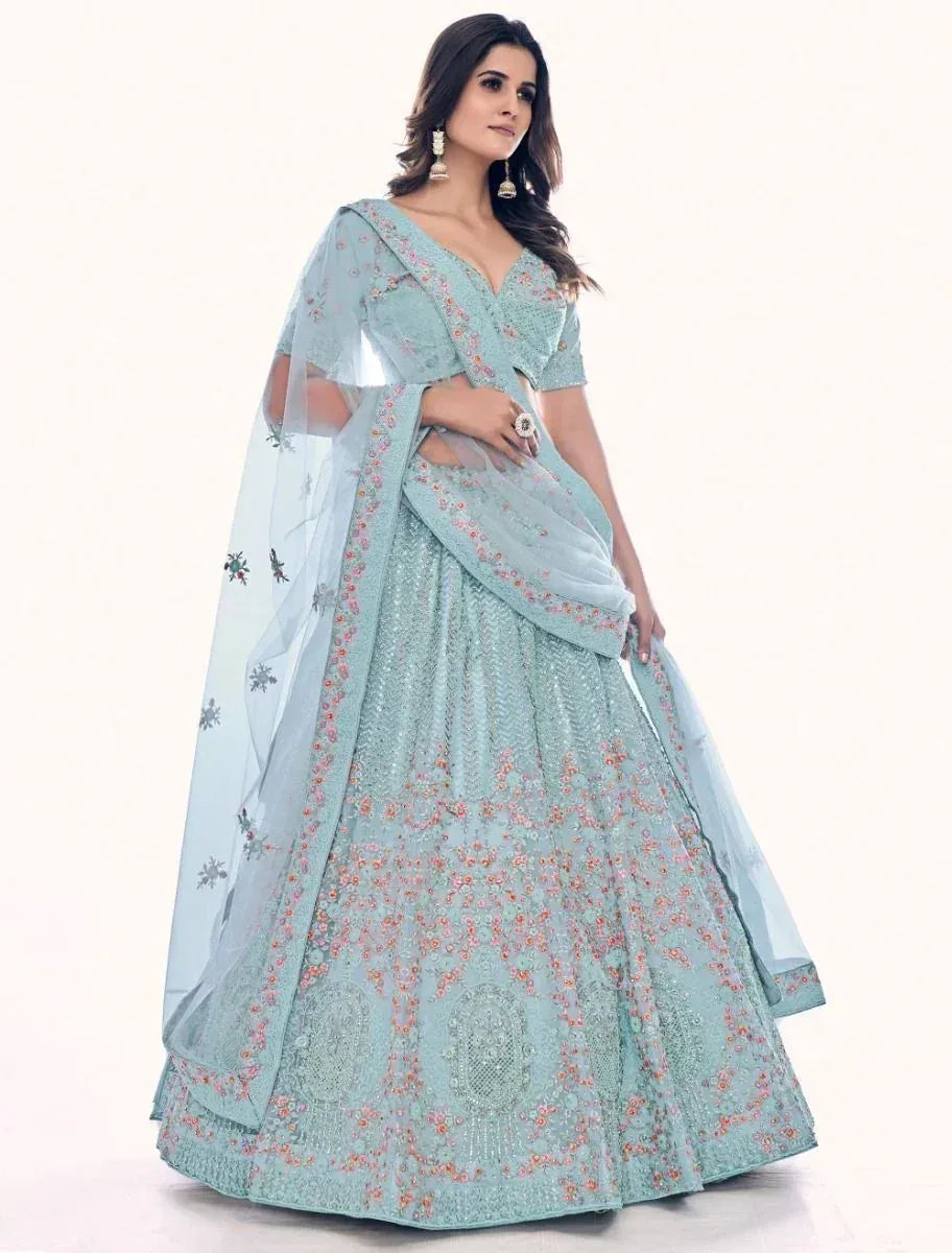 Light blue designer lehenga choli with floral embroidery and sheer dupatta, perfect for weddings and festive occasions.