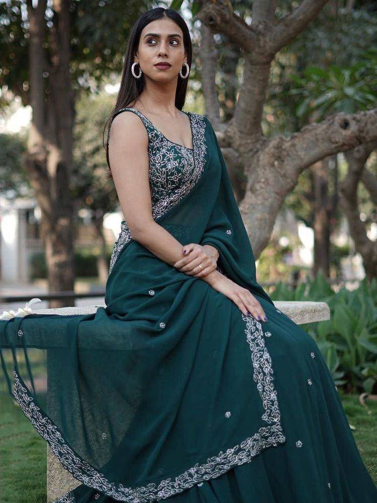 Elegant dark green embroidered saree with silver detailing, perfect for Indian ethnic occasions.