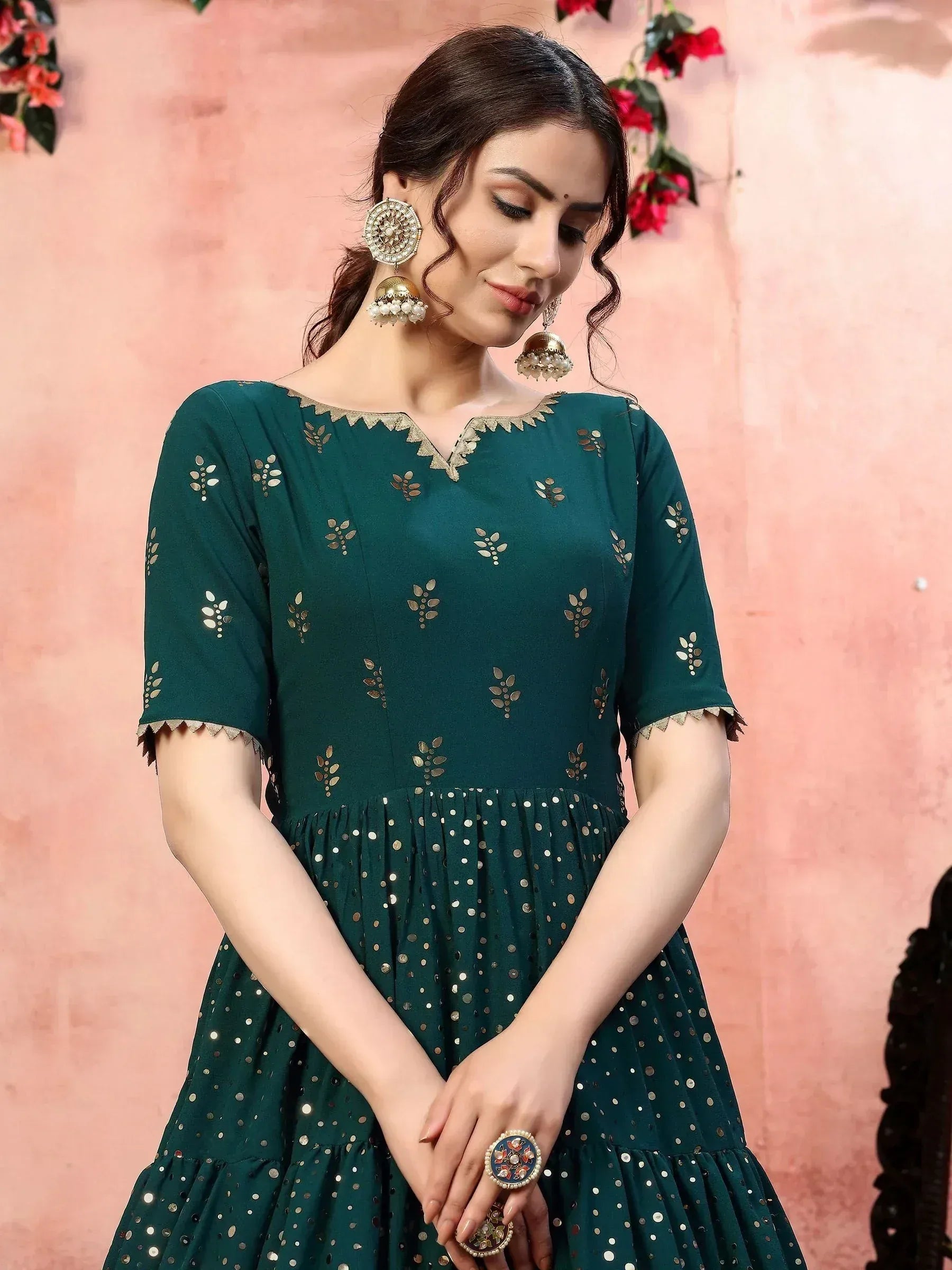Emerald green ethnic gown with gold mirror work, scalloped neckline, and flared skirt for festive occasions