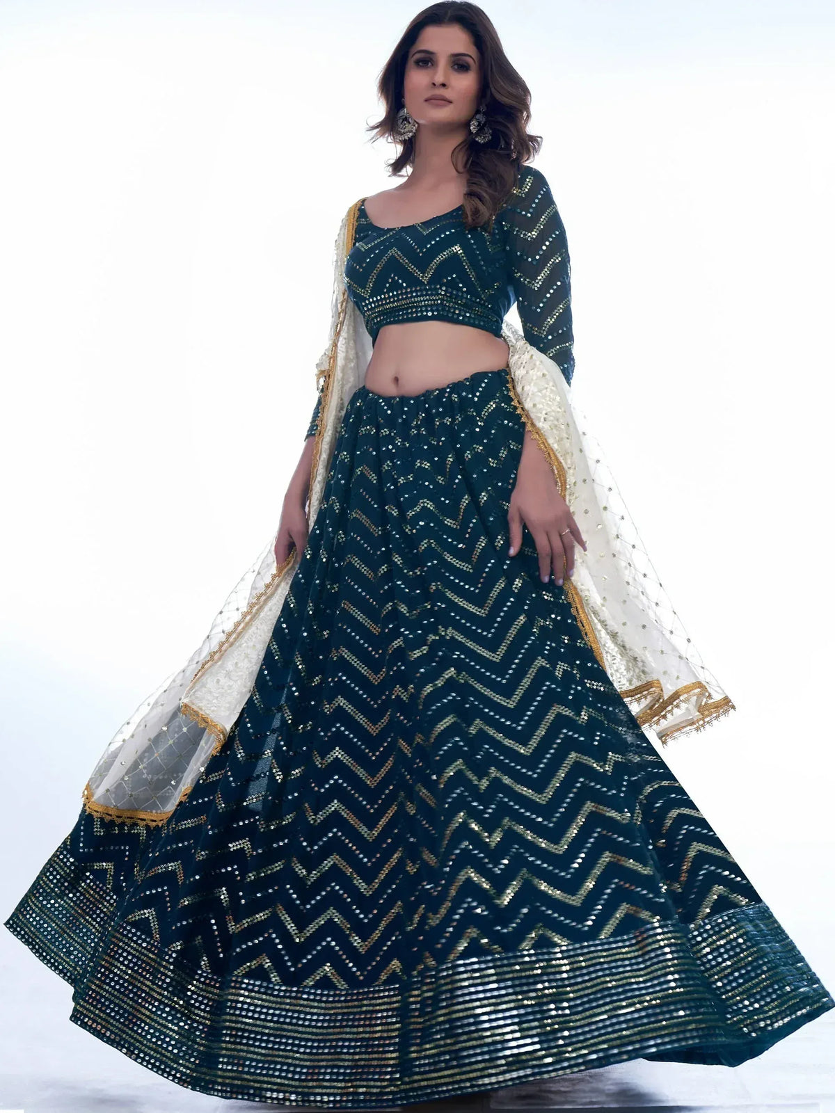 Emerald green sequin lehenga choli with gold zigzag embroidery and sheer dupatta, perfect for Indian ethnic wear events.
