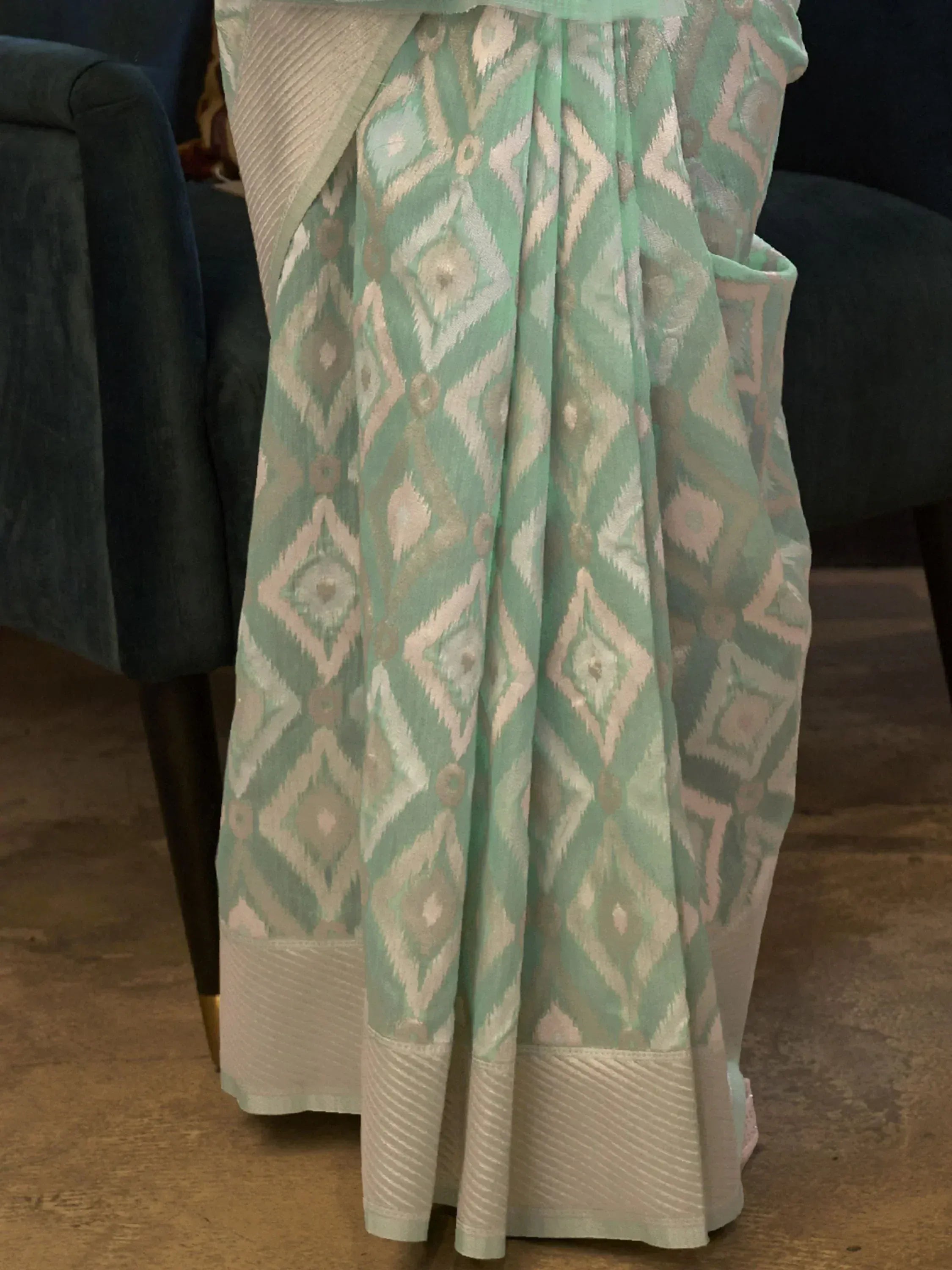 Mint green ikat print ethnic saree with geometric pattern and pleated border