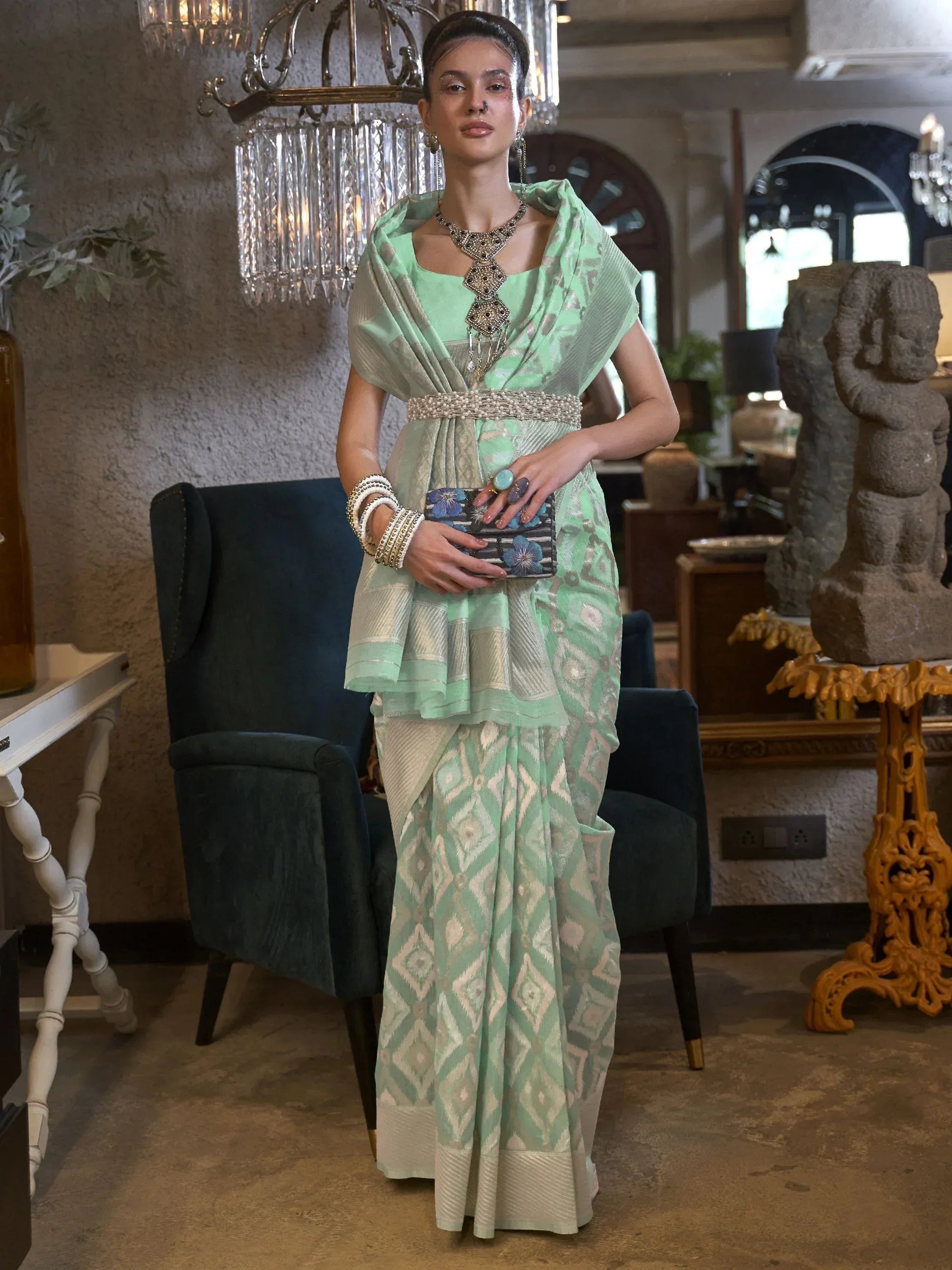 Mint green ethnic saree with geometric print, peplum blouse, and statement jewelry for Indian occasions