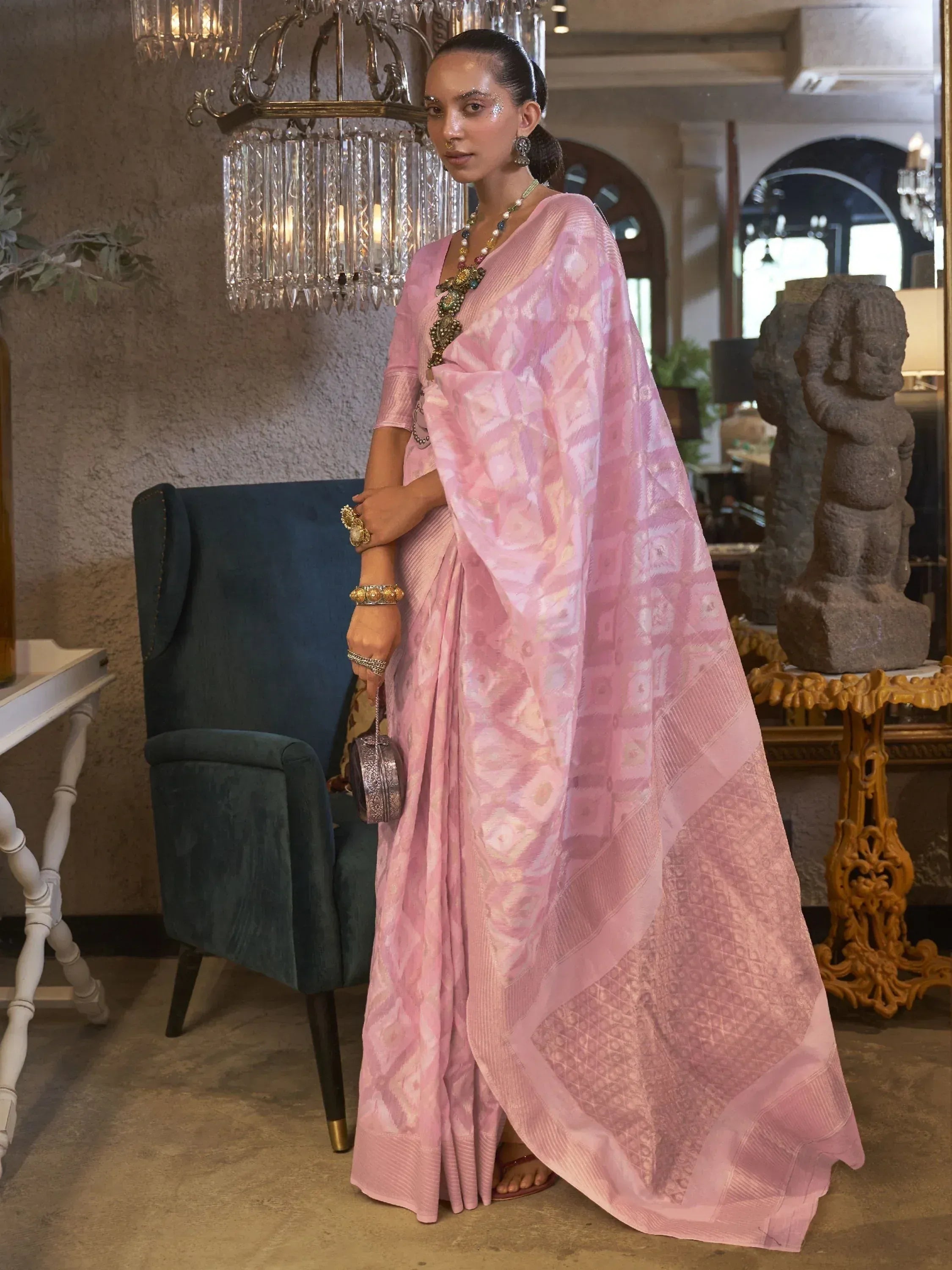 Pink printed saree with ethnic jewelry, styled for Indian festive occasions