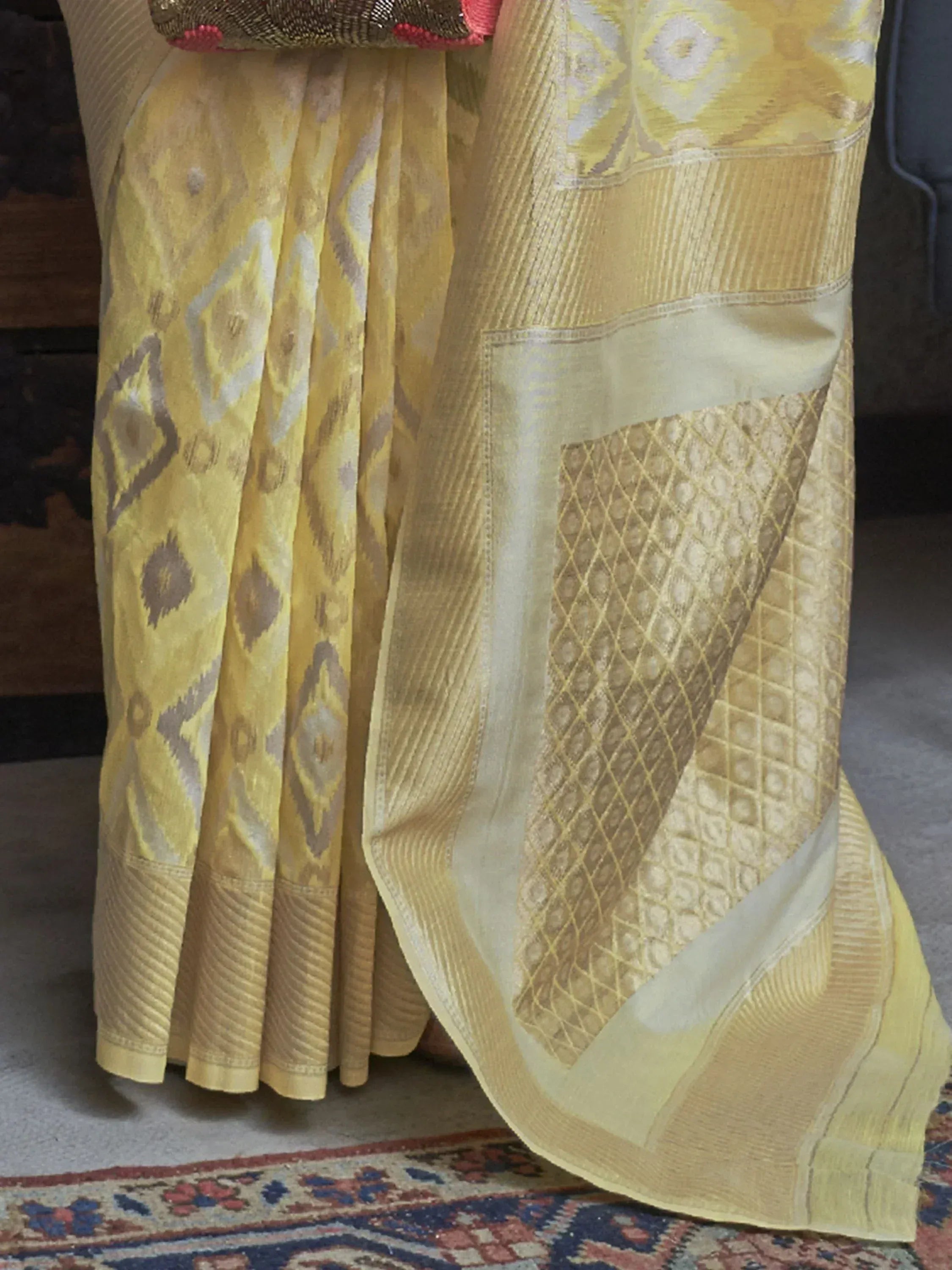 Yellow ikat patterned Indian saree with gold border, ethnic wear for women