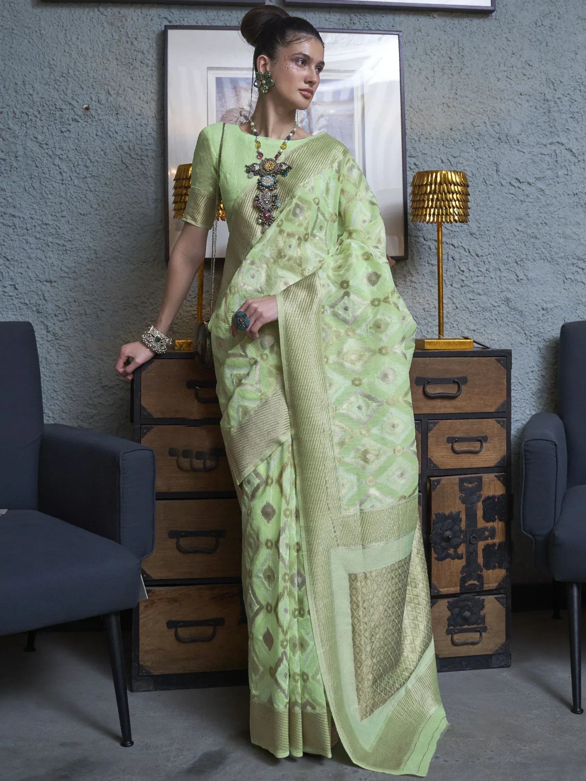 Light green designer saree with geometric print, ethnic wear for women, styled with statement jewelry
