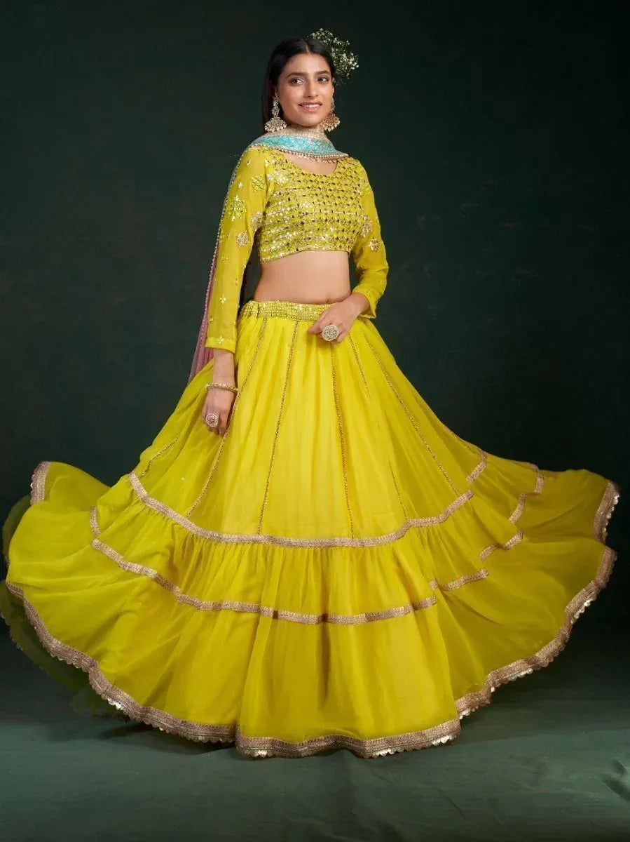 Vibrant yellow designer lehenga choli with gold embroidery, perfect for Indian ethnic wear events