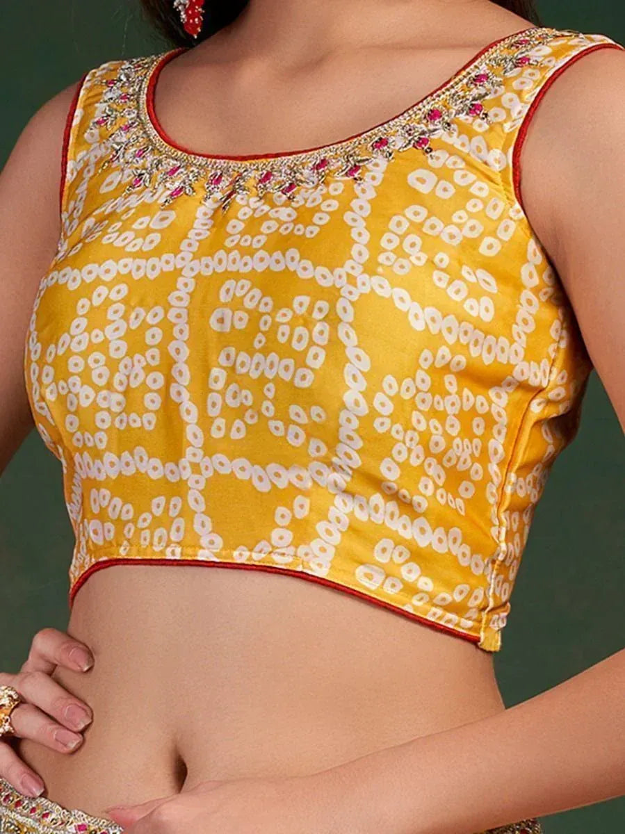 Yellow printed designer blouse with embroidered neckline, perfect for lehenga choli or saree