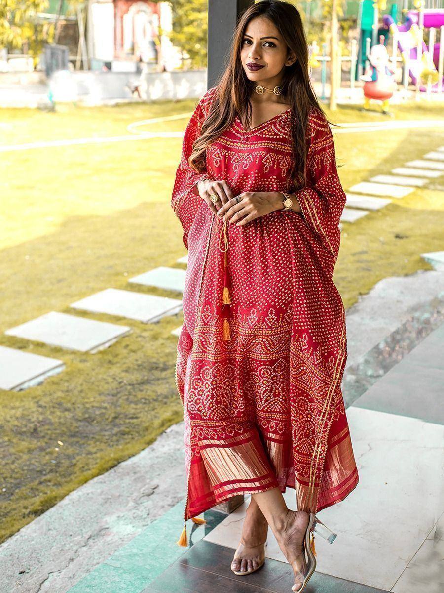 Red printed ethnic gown with gold detailing, perfect for Indian occasions and festive wear