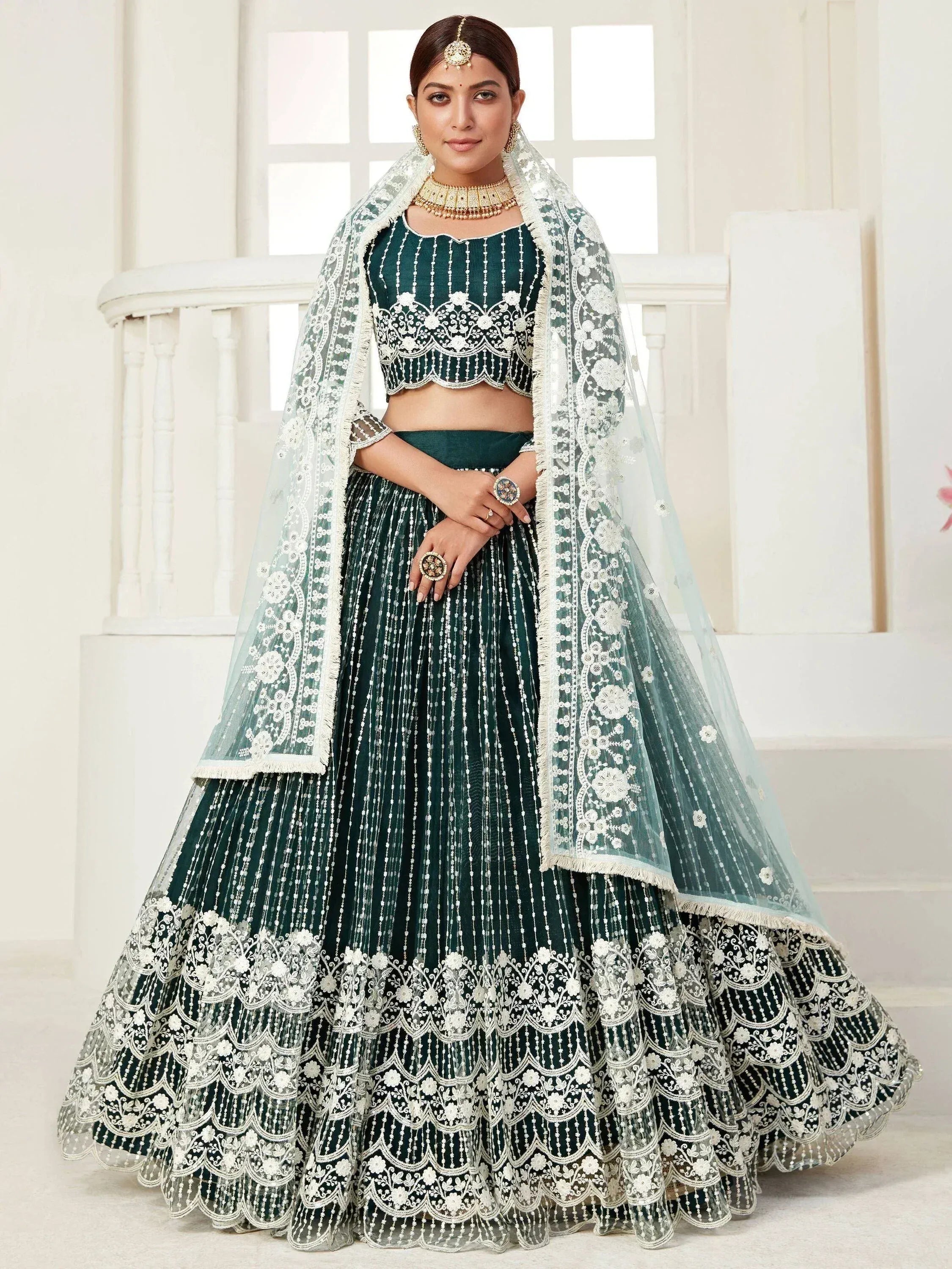 Emerald green designer lehenga choli with white floral embroidery and sheer dupatta for Indian weddings