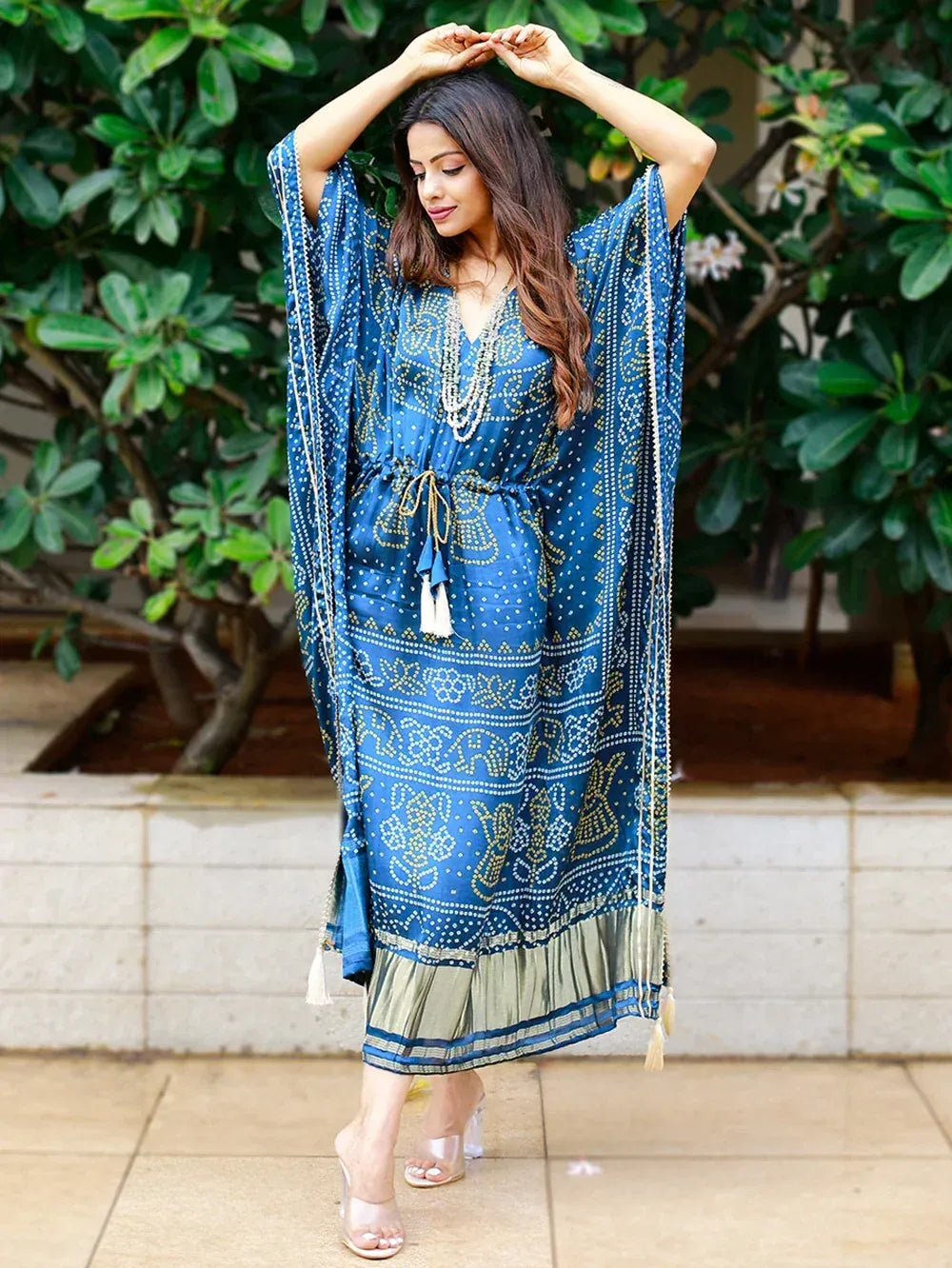 Blue printed ethnic kaftan gown with gold motifs, tassels, and ruffle hem for women