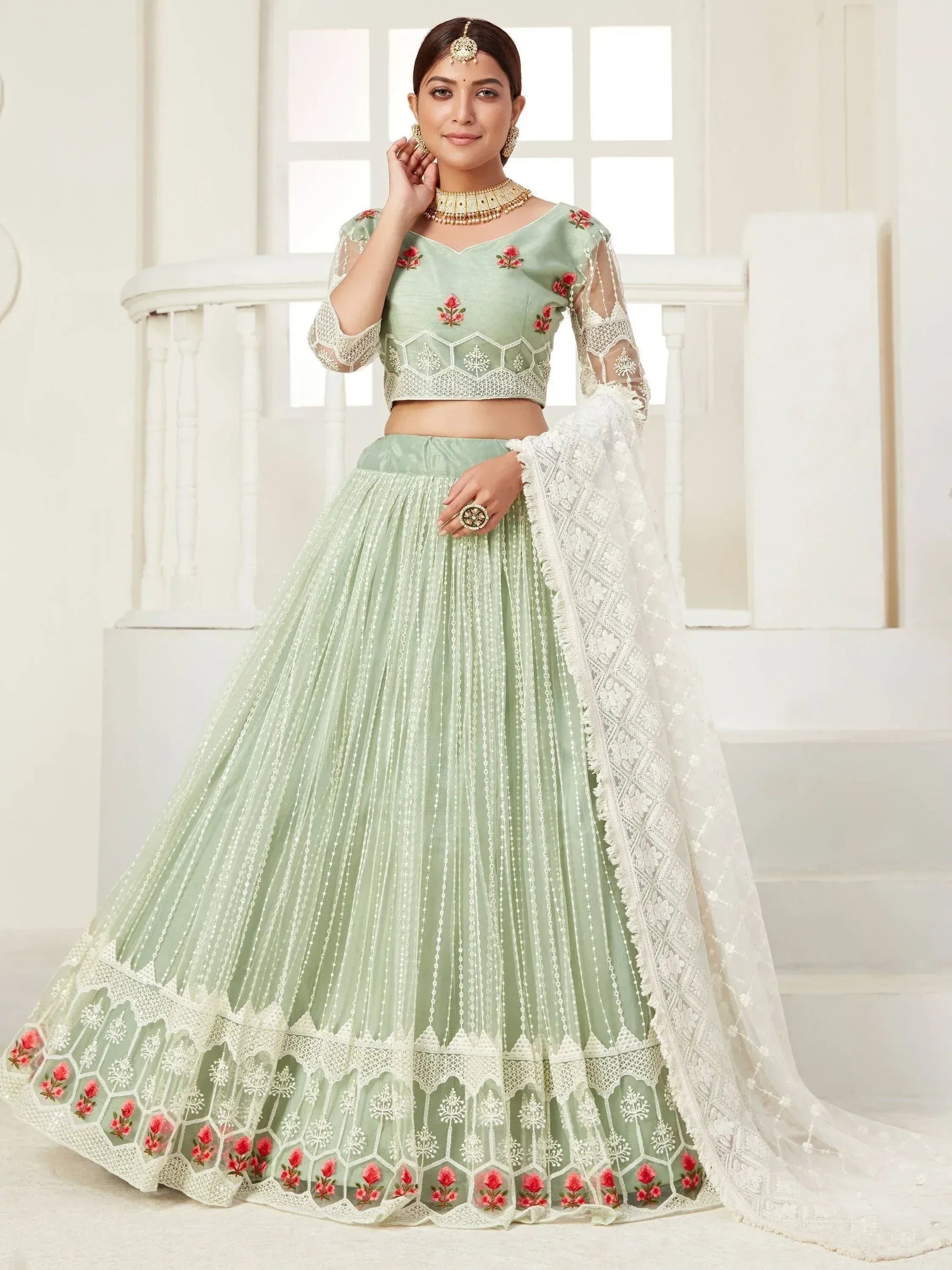 Mint green embroidered lehenga choli with floral detailing and lace dupatta for Indian ethnic wear
