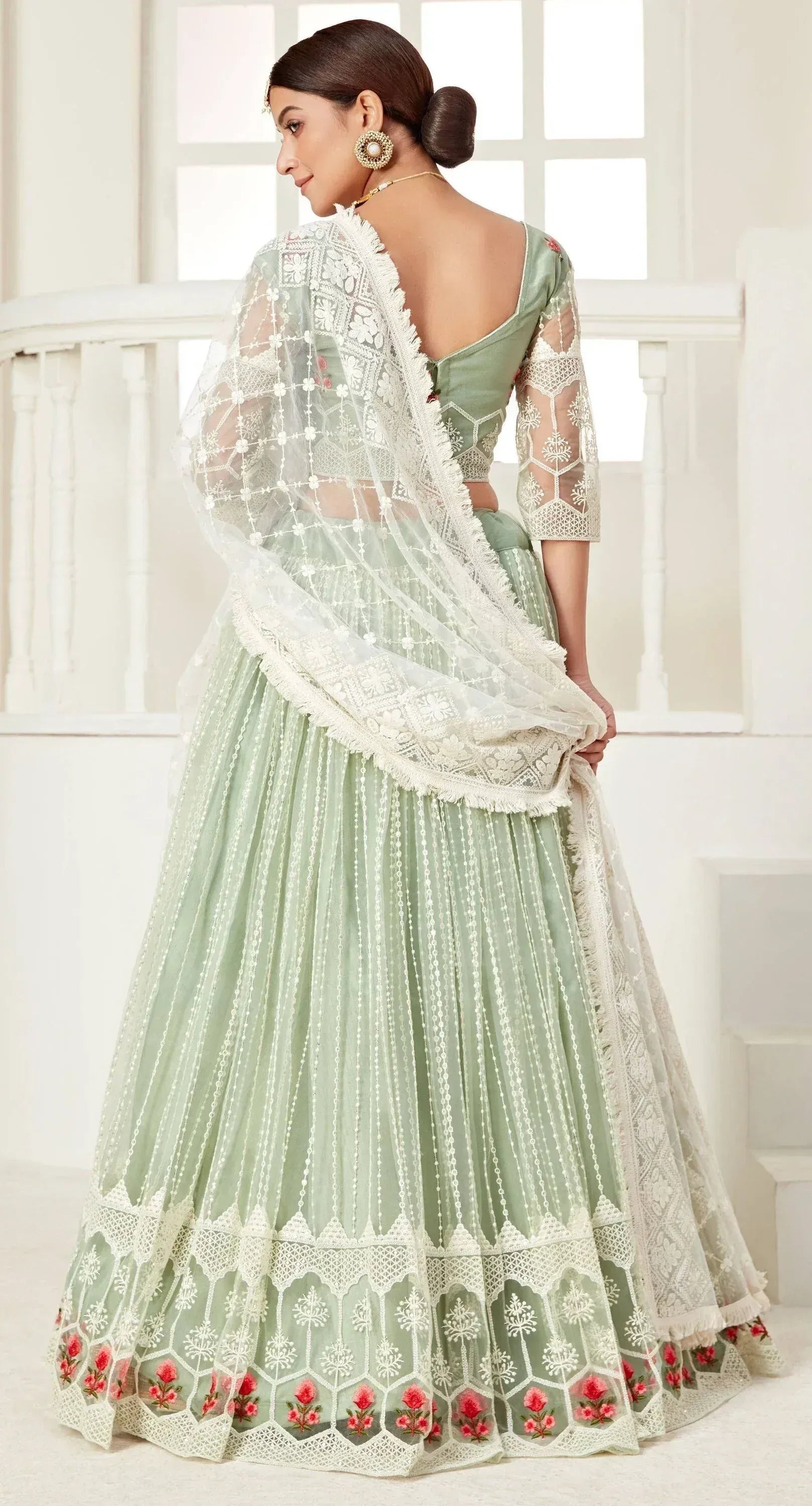 Mint green designer lehenga choli with white lace and floral embroidery, back view