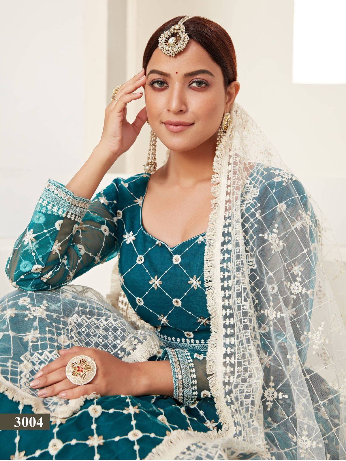 Teal embroidered lehenga choli with white net dupatta, perfect for Indian ethnic wear occasions