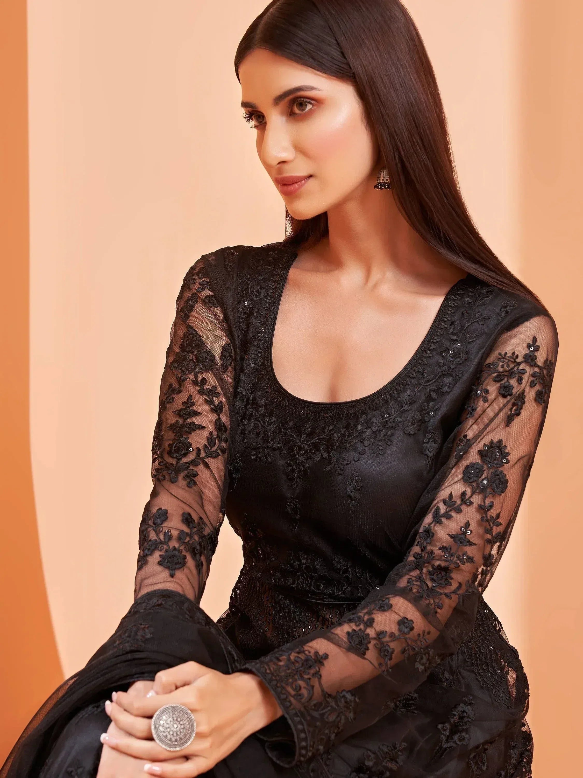Elegant black embroidered ethnic gown with sheer floral sleeves, perfect for festive occasions.
