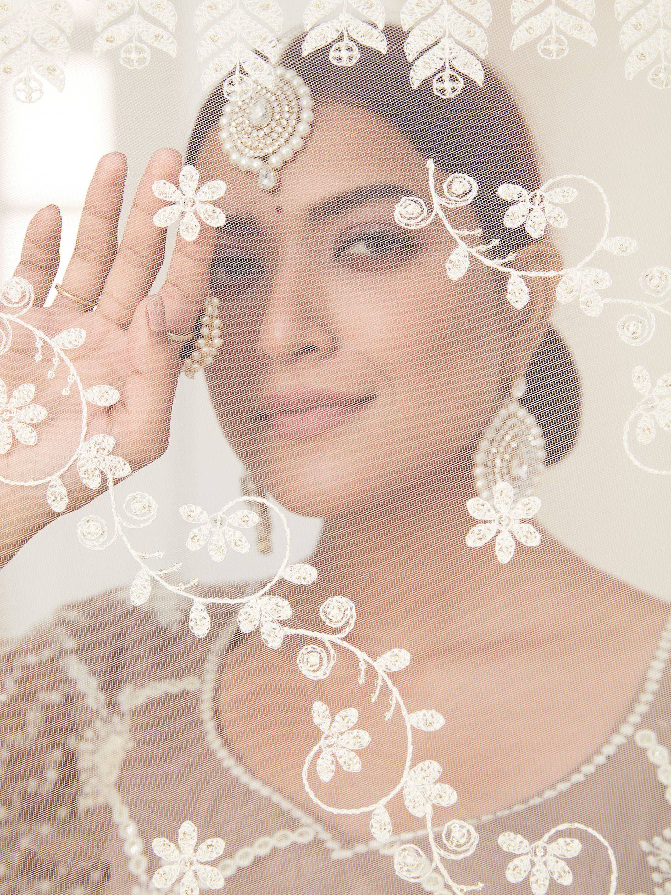 Elegant white embroidered dupatta with floral lace, perfect for Indian bridal wear and ethnic occasions.