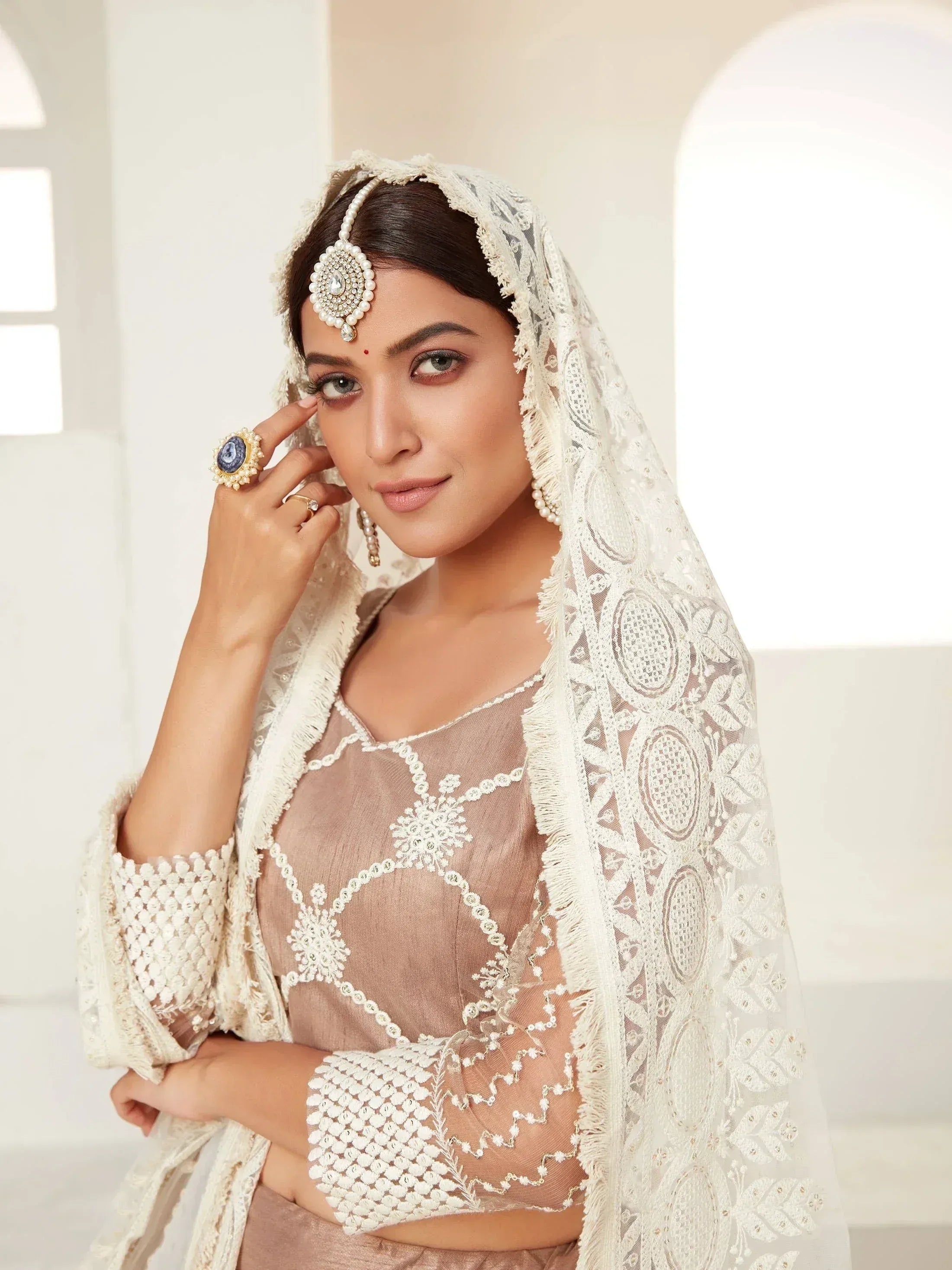 Elegant Indian ethnic wear with lace dupatta and pearl jewelry, perfect for weddings and special occasions.