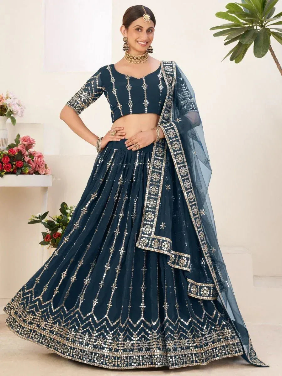 Navy blue designer lehenga choli with gold mirror work, perfect for weddings and festive occasions.