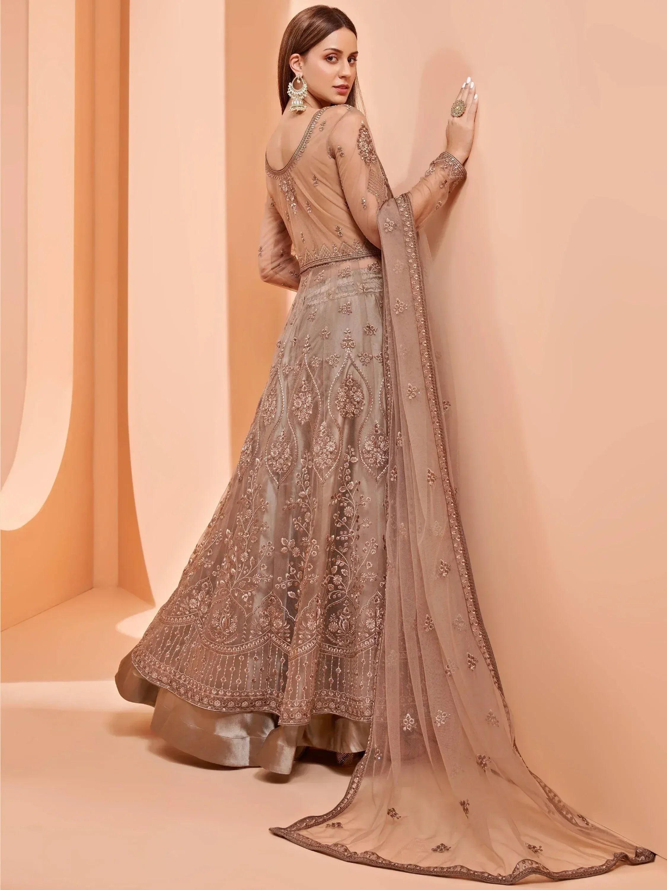 Elegant beige embroidered lehenga choli with sheer dupatta, perfect for Indian weddings and festive occasions.