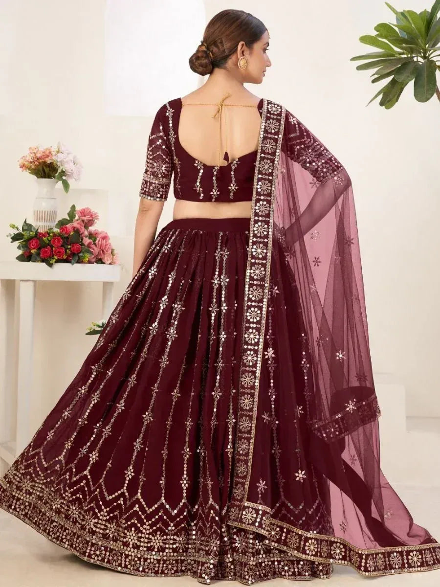 Maroon lehenga choli with gold mirror work and sheer dupatta, elegant Indian ethnic wear for weddings
