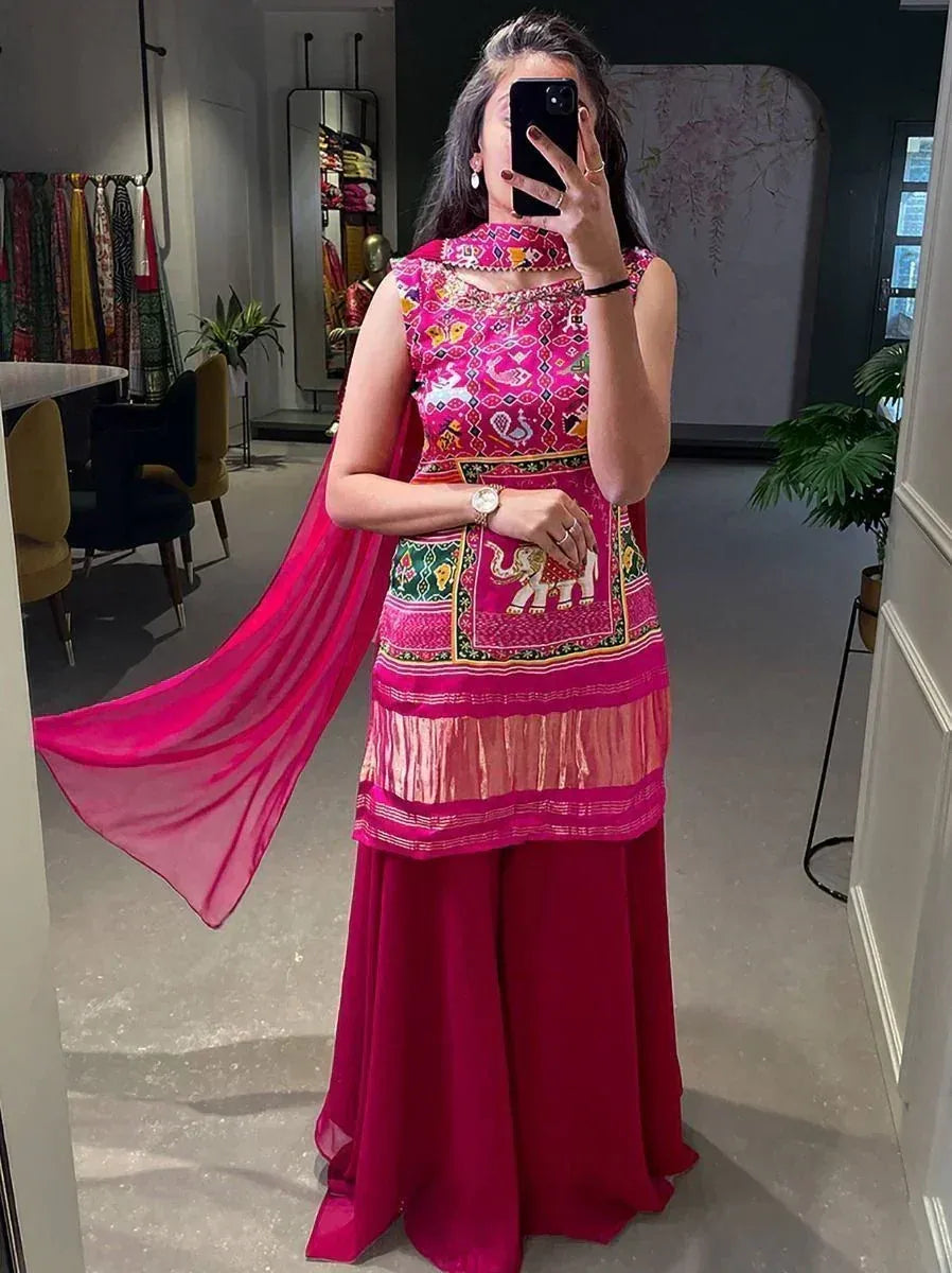Vibrant pink embroidered ethnic gown with elephant motifs and matching dupatta, perfect for festive occasions.