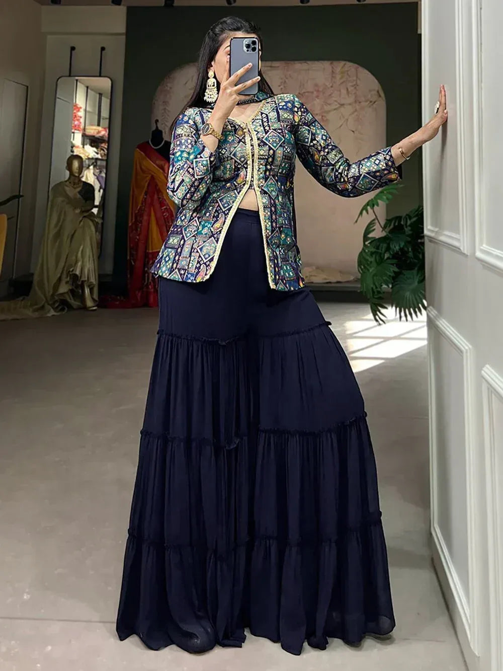 Woman in printed ethnic jacket and navy tiered palazzo pants, stylish Indian wear